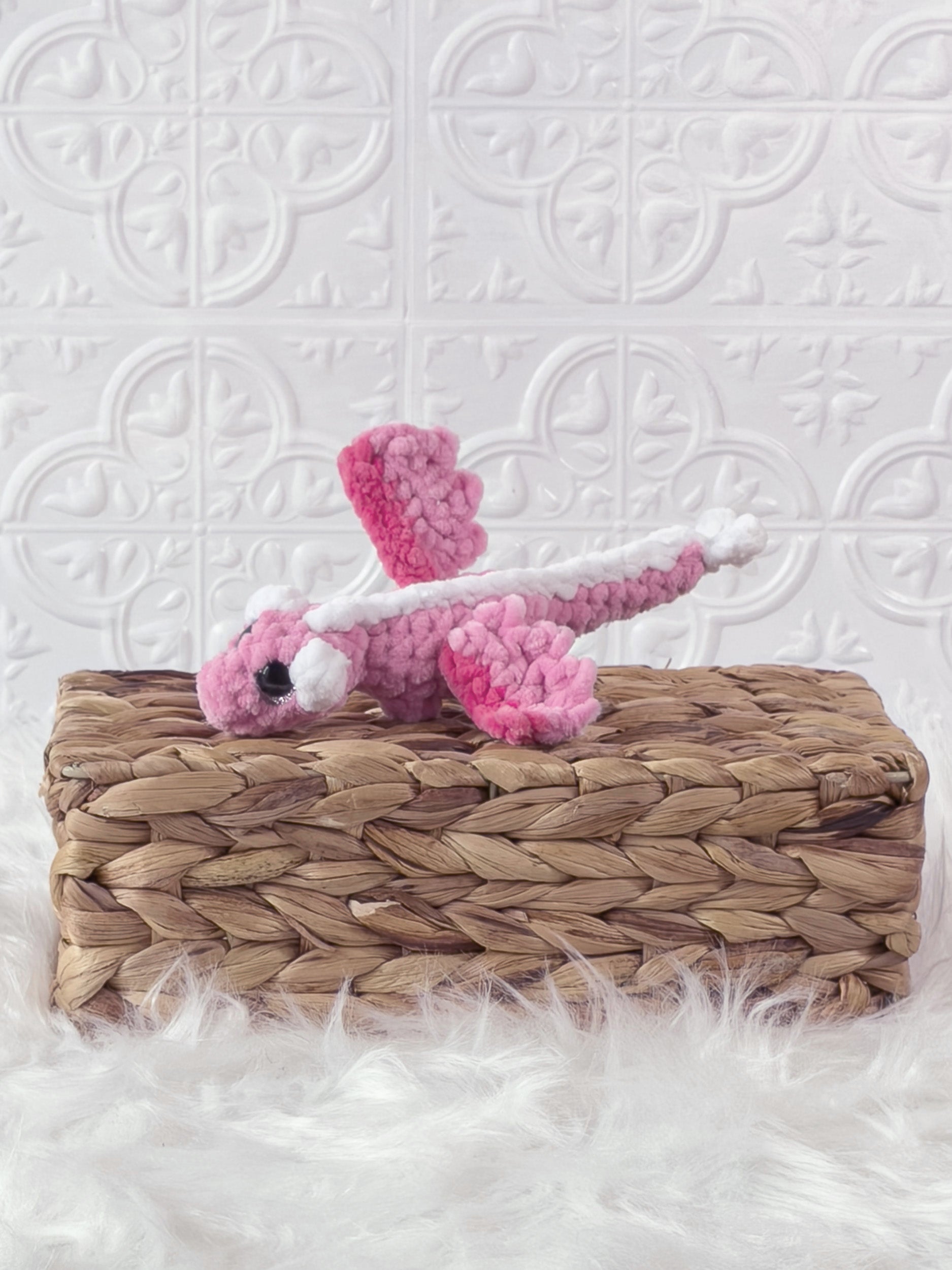 Small handmade dragon crochet plushie shown from the front
