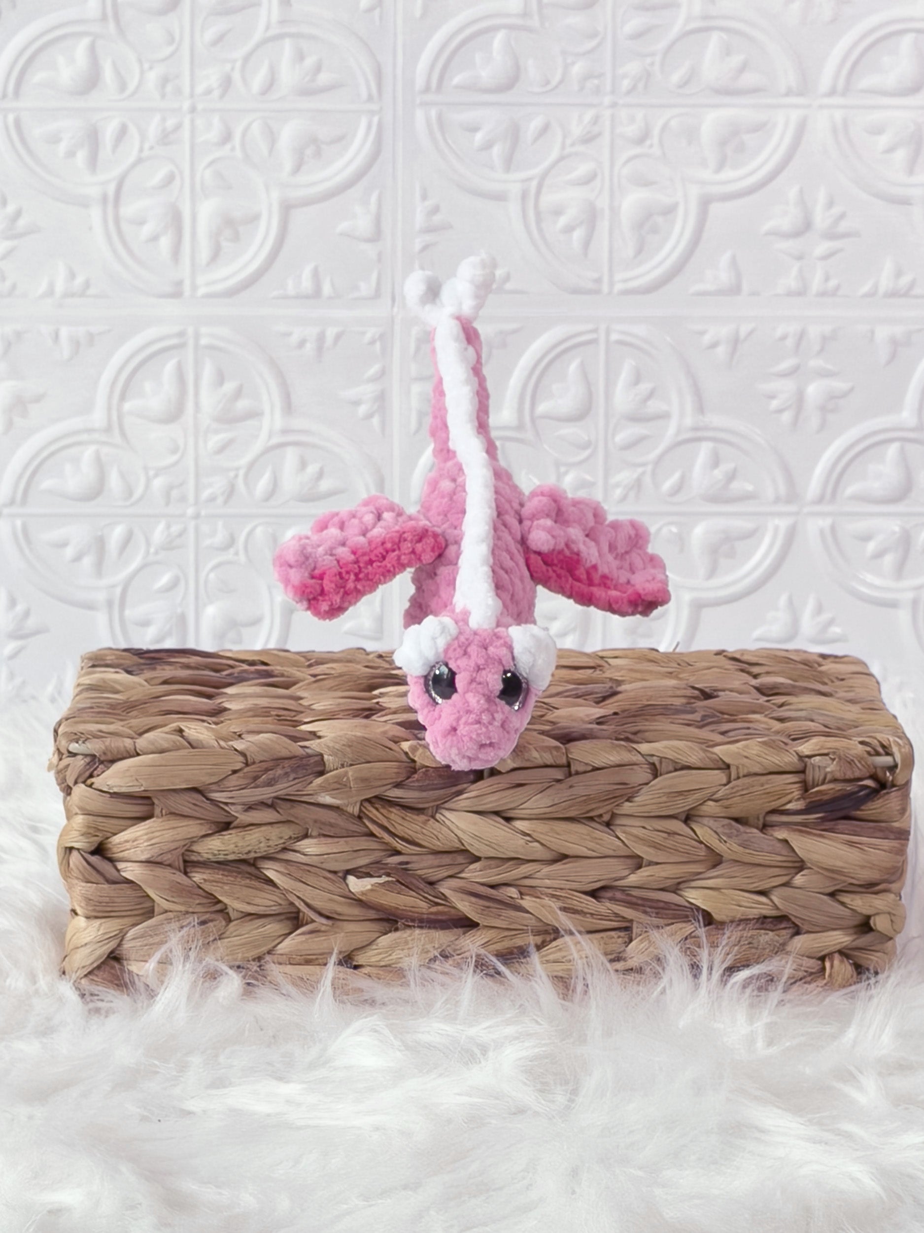 Handmade pink mini dragon crochet plushie shown from the front