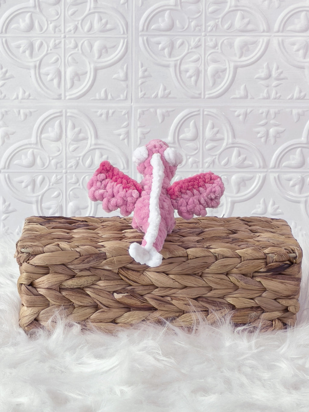 Handmade pink mini dragon crochet plushie shown in a product image