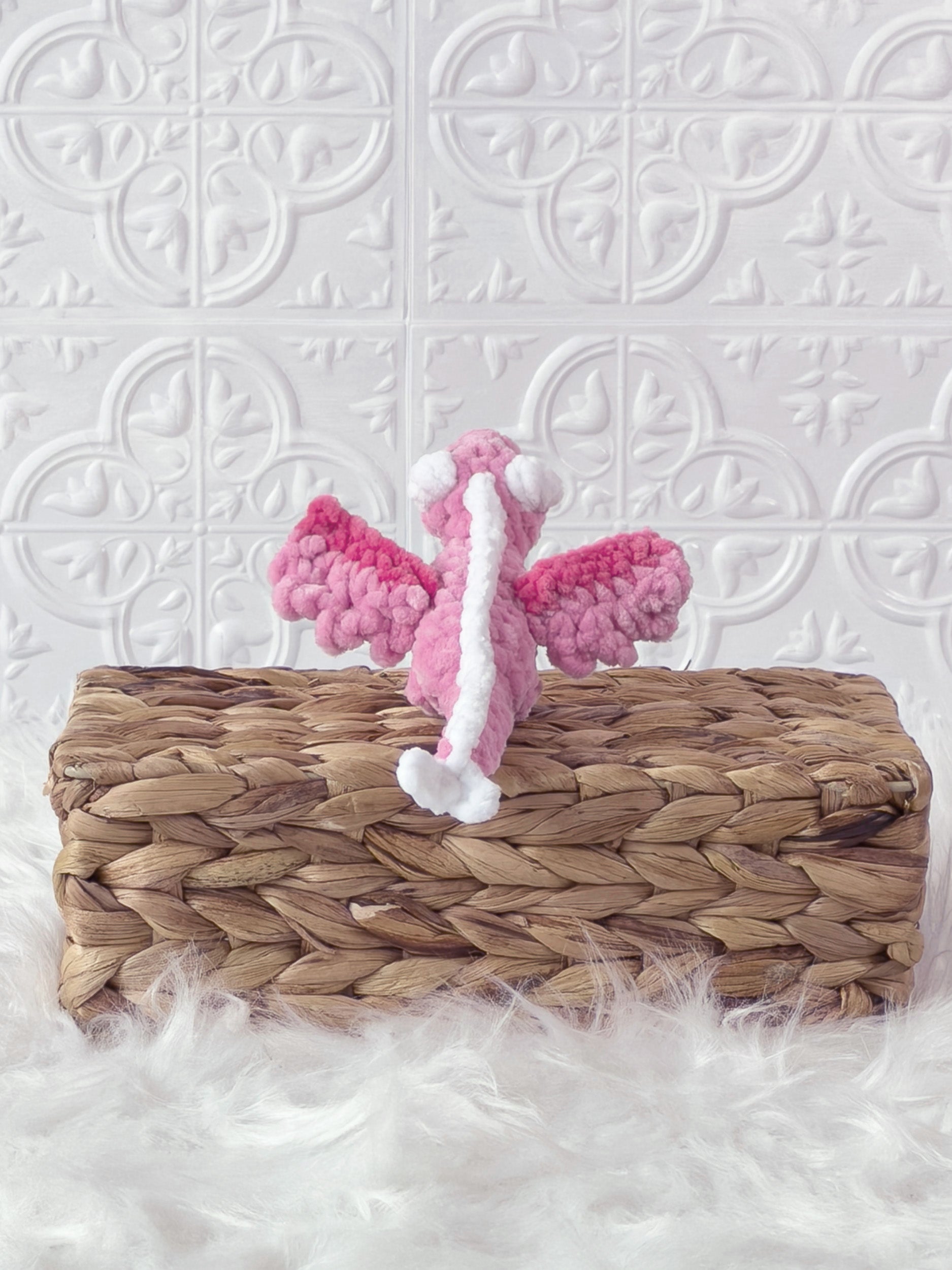 Handmade pink mini dragon crochet plushie shown in a product image