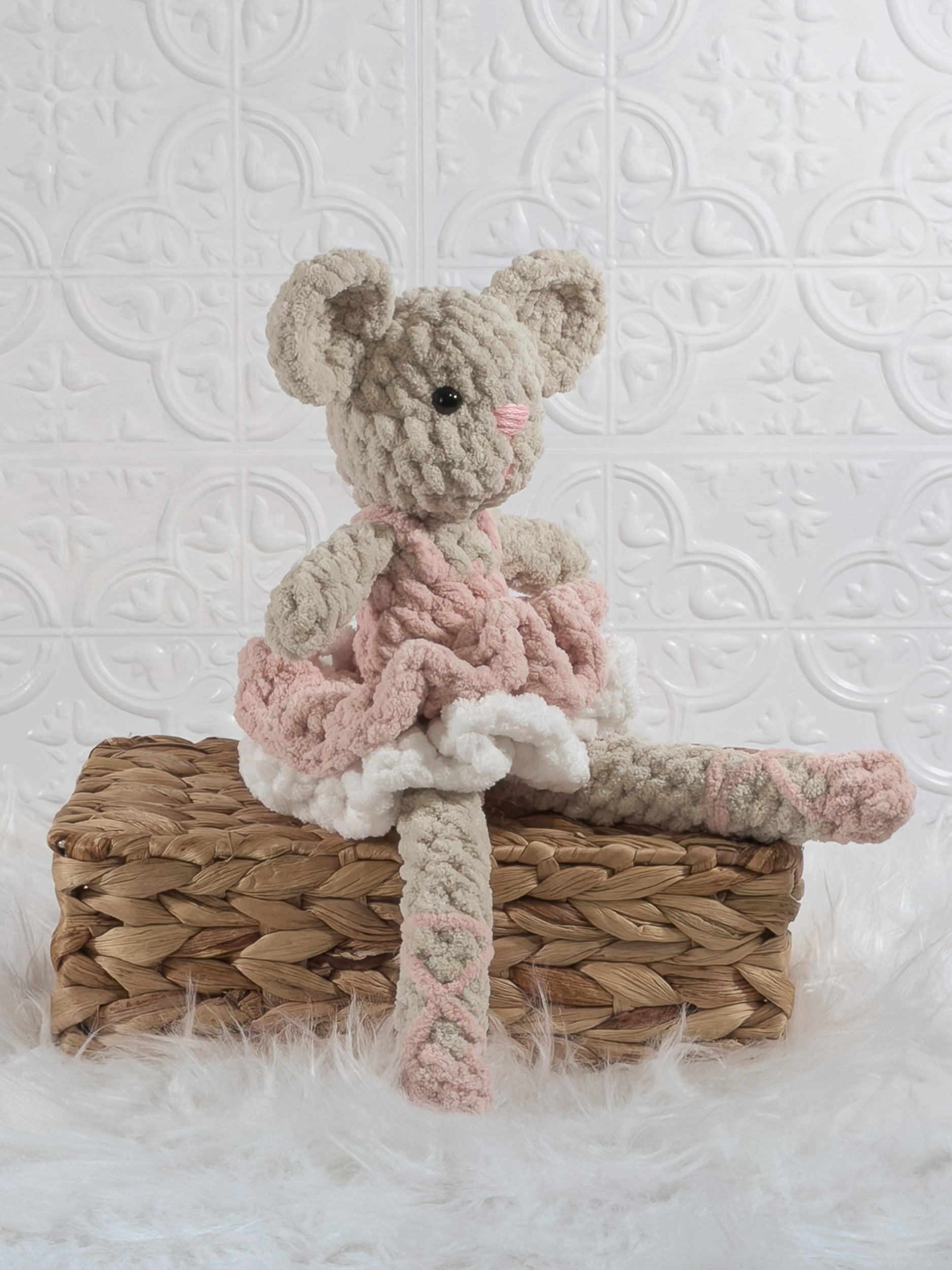 Handmade pink mouse ballerina crochet plushie shown from an angled view