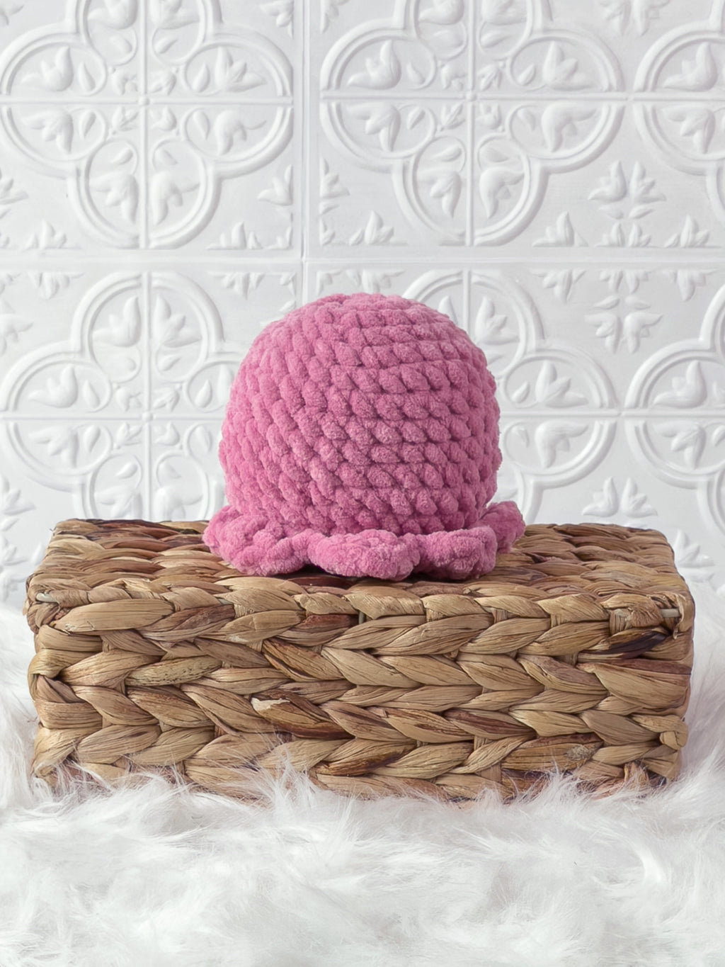 Handmade pink octopus crochet plushie shown from the back