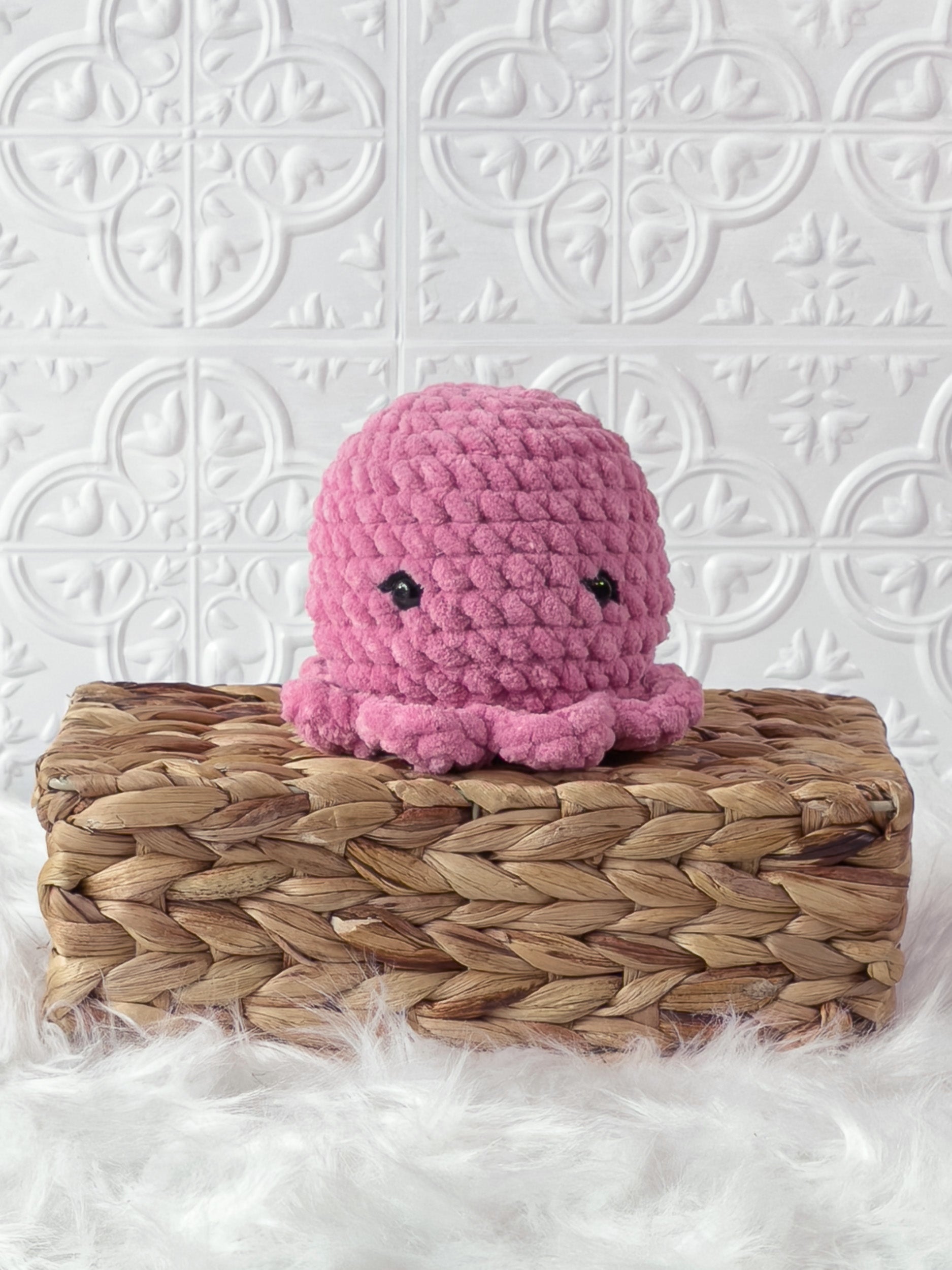 Handmade pink octopus crochet plushie shown from the front