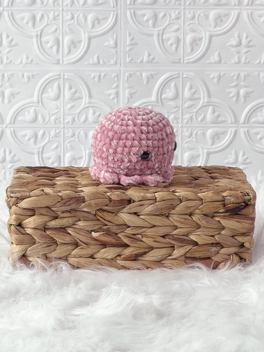 Handmade pink octopus crochet plushie shown from an angled view