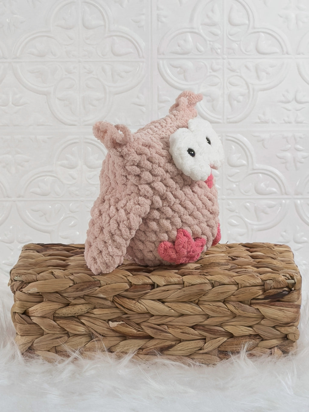 Handmade pink owl crochet plushie shown from an angled view
