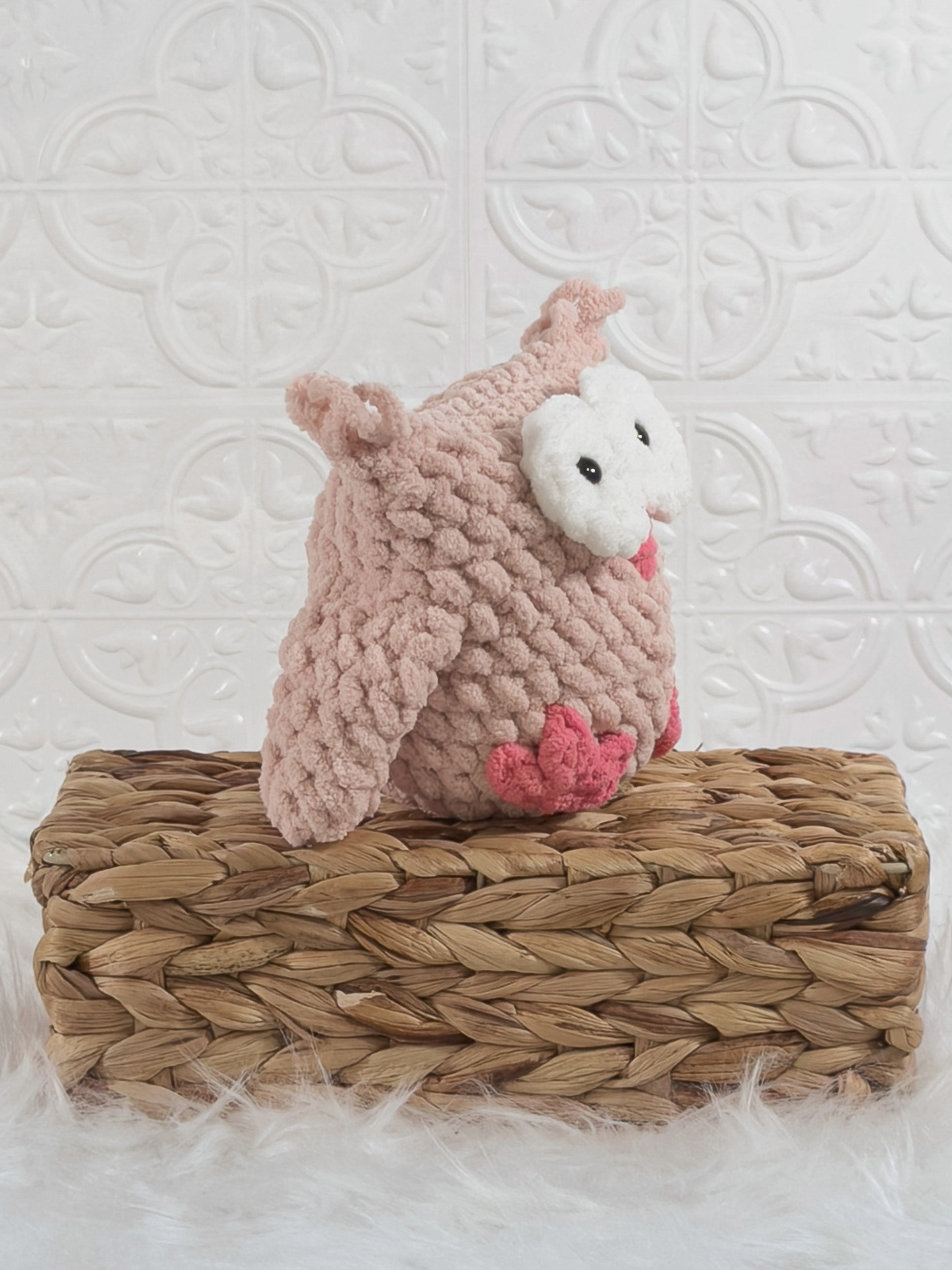 Handmade pink owl crochet plushie shown from an angled view