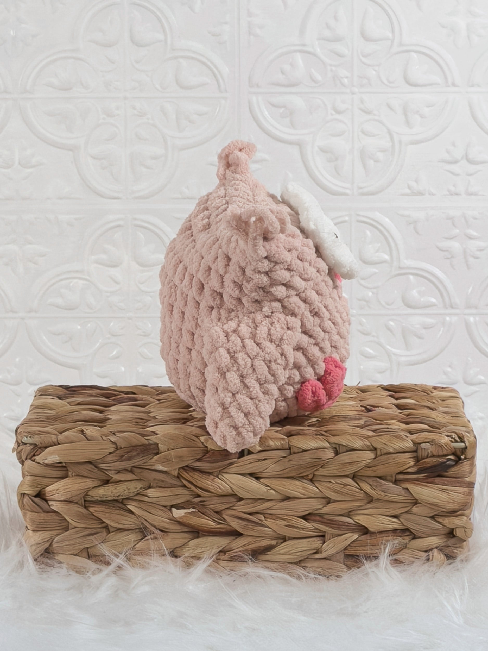 Handmade pink owl crochet plushie shown from the side