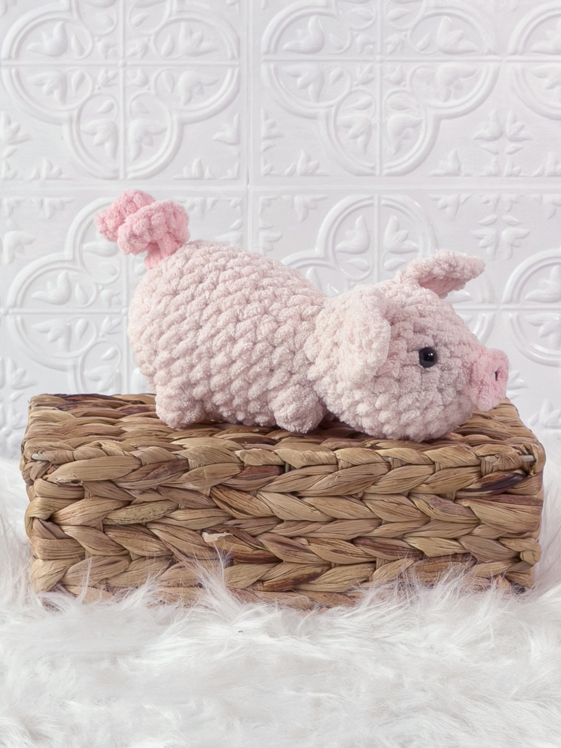 Handmade pink pig crochet plushie shown from an angled view