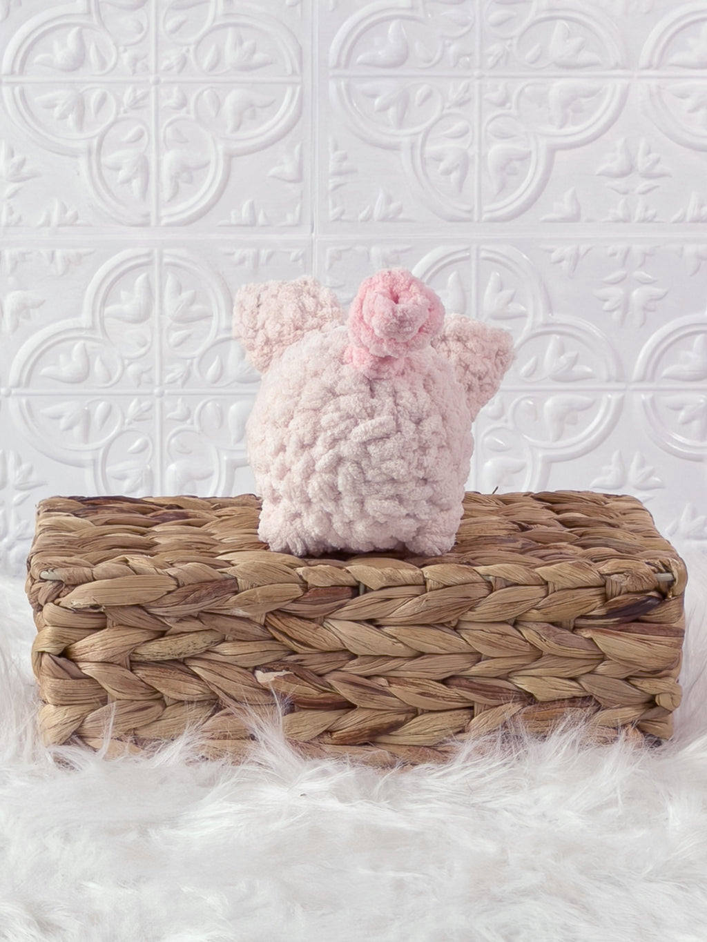 Handmade pink pig crochet plushie shown from the back