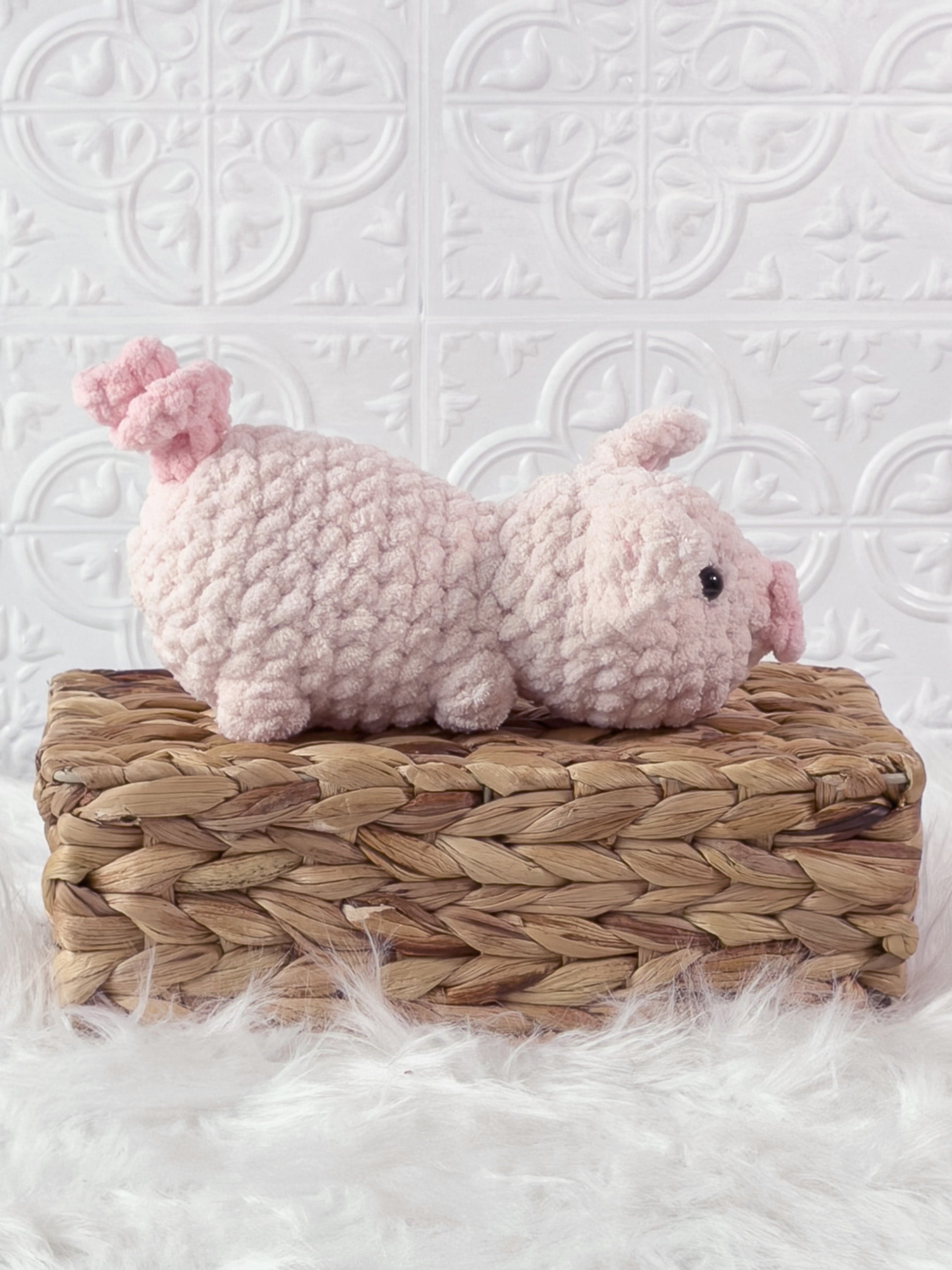 Handmade pink pig crochet plushie shown from the side