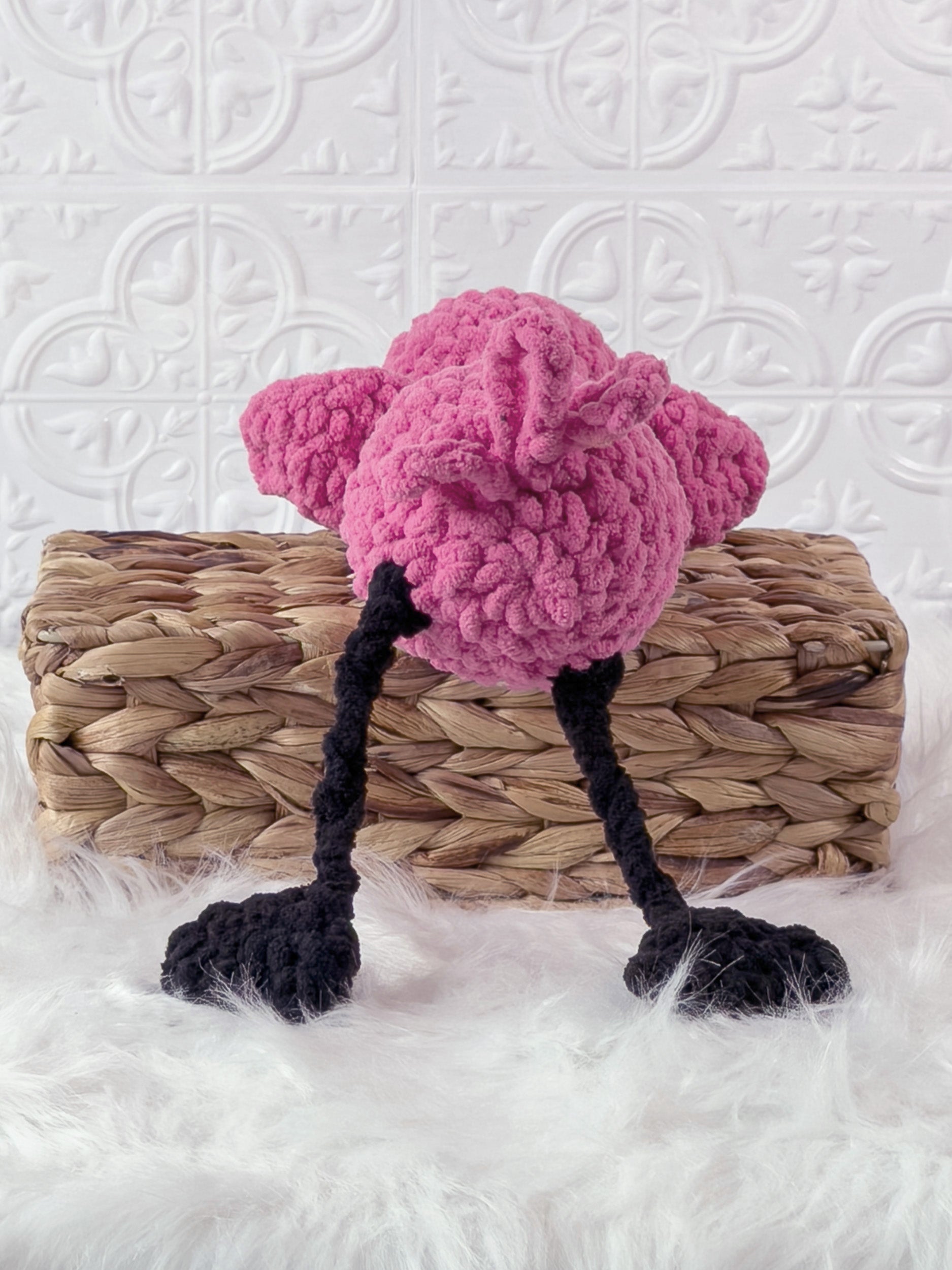 Handmade pink silly flamingo crochet plushie shown from the back