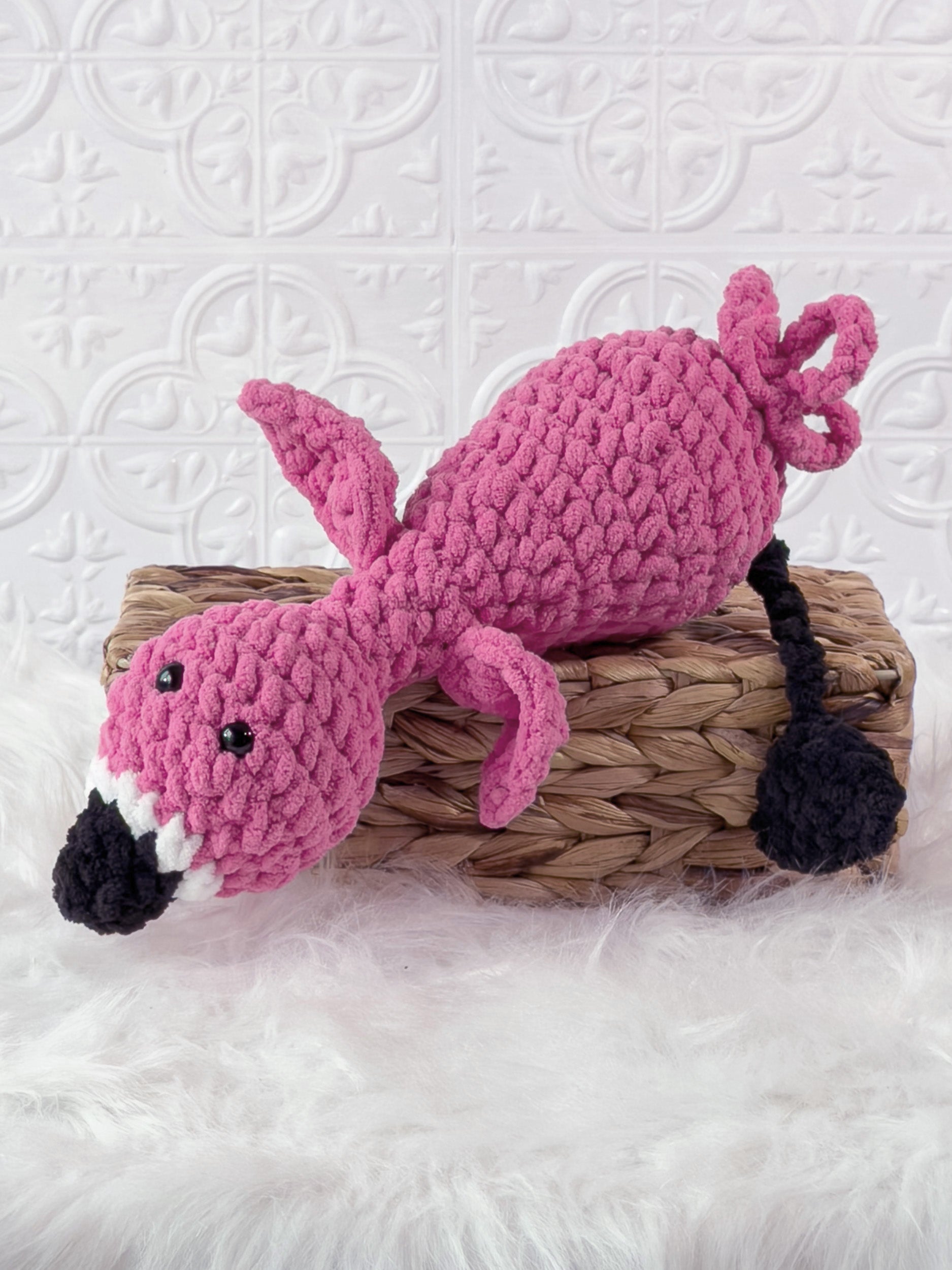 Handmade pink silly flamingo crochet plushie shown from the front
