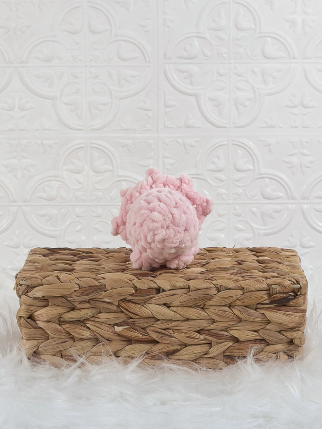 Handmade pink triceratops crochet plushie shown from the back
