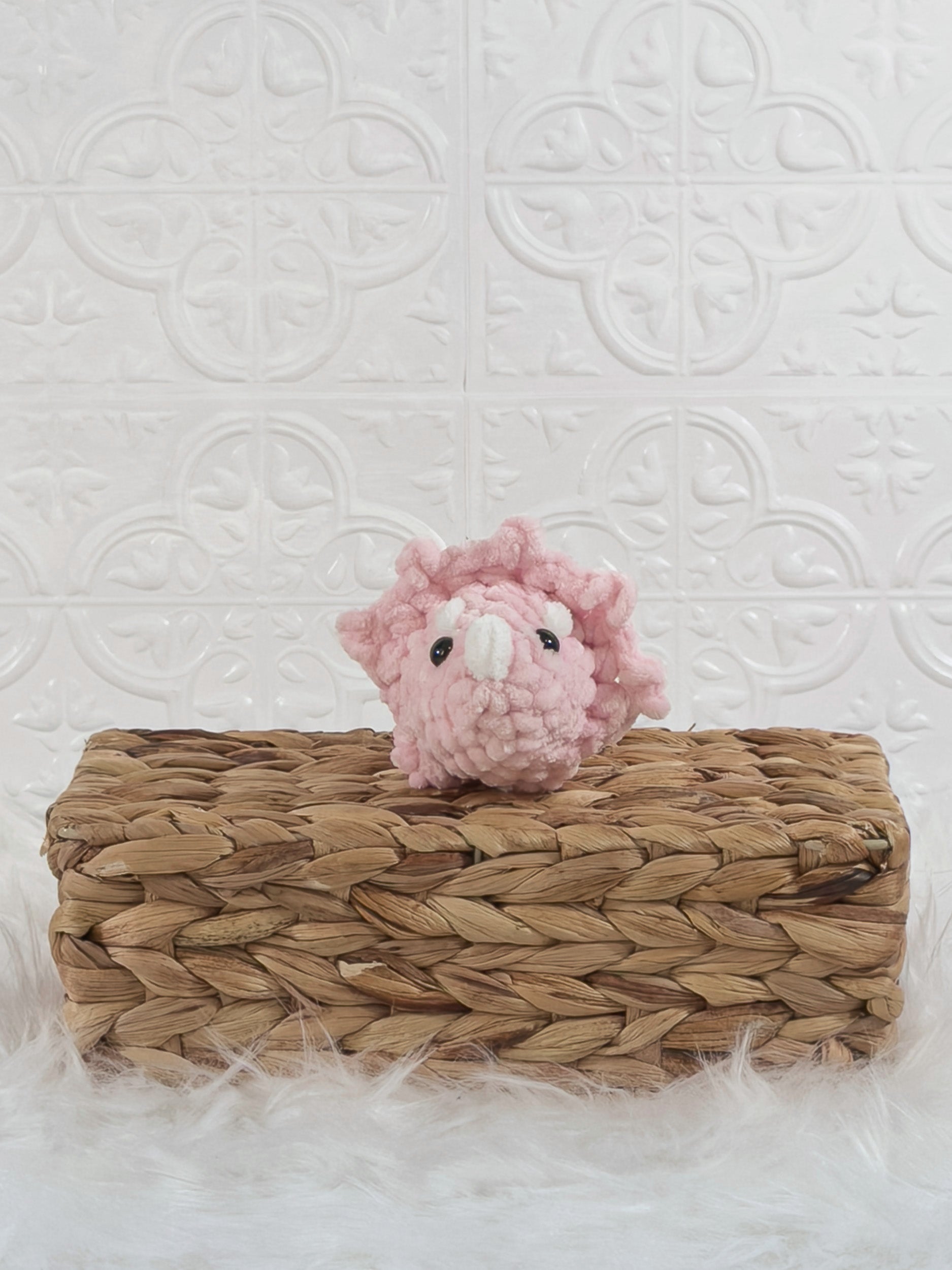 Handmade pink triceratops crochet plushie shown from the front