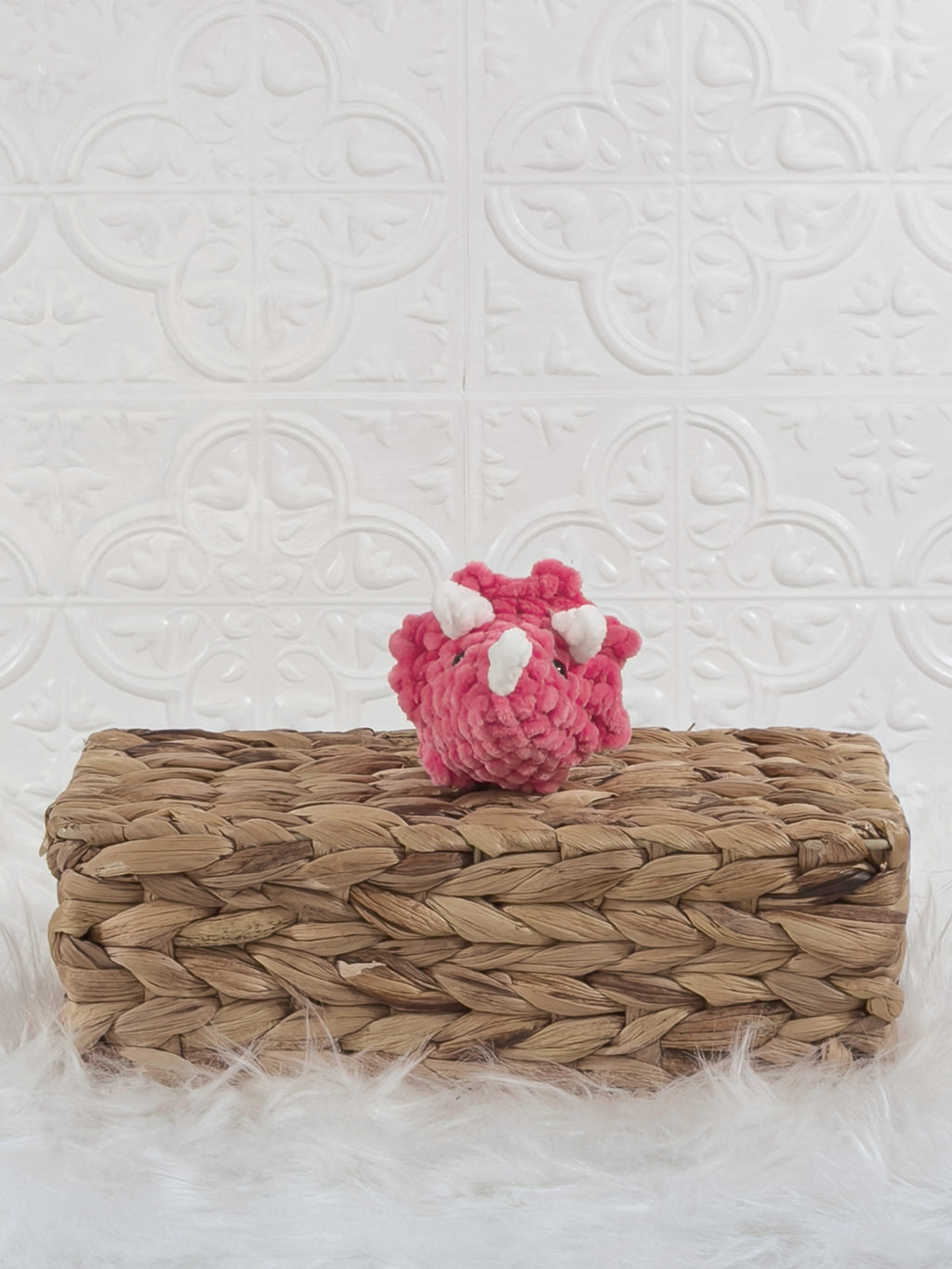 Handmade pink triceratops crochet plushie shown from the front