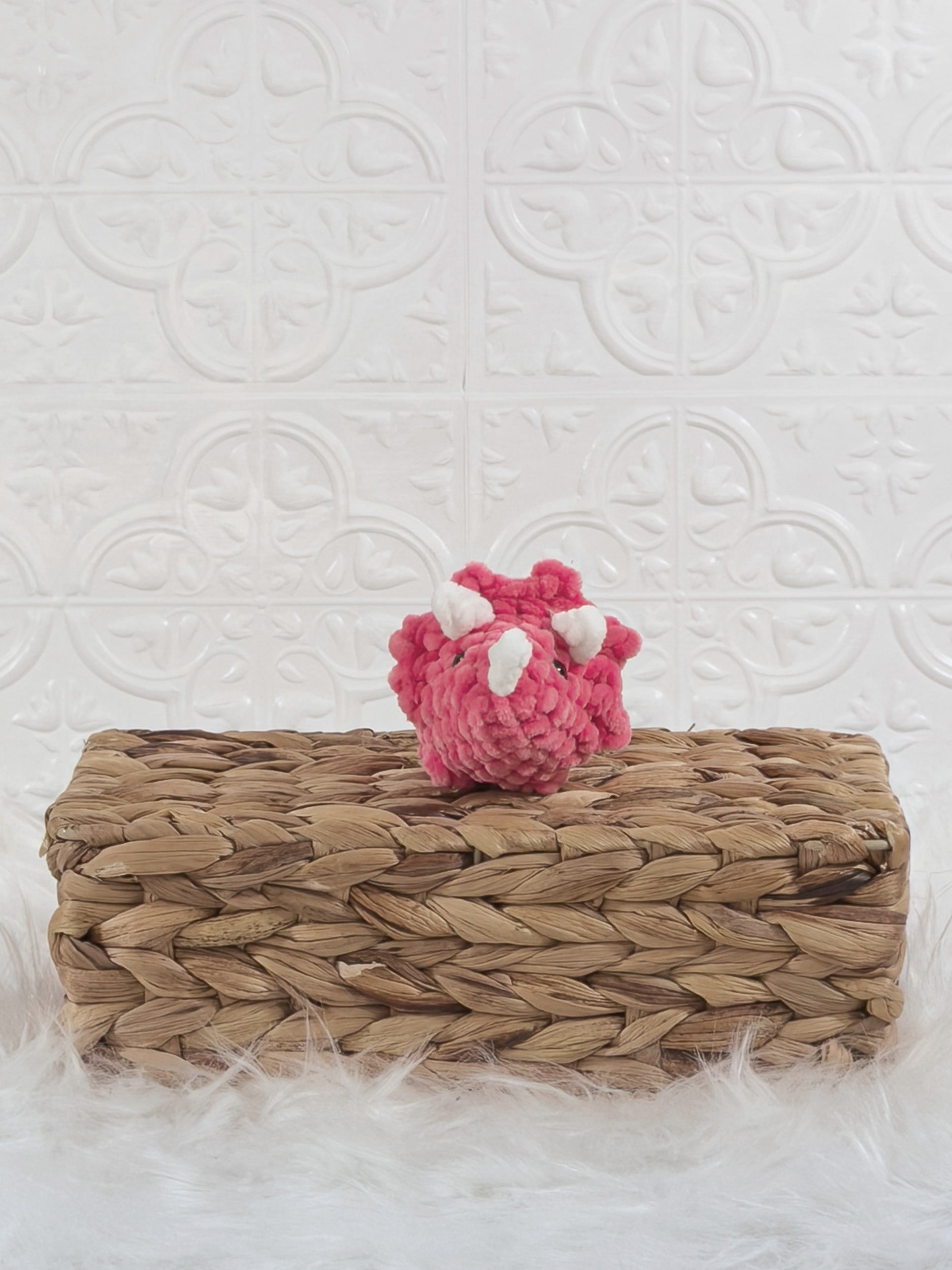 Handmade pink triceratops crochet plushie shown from the front