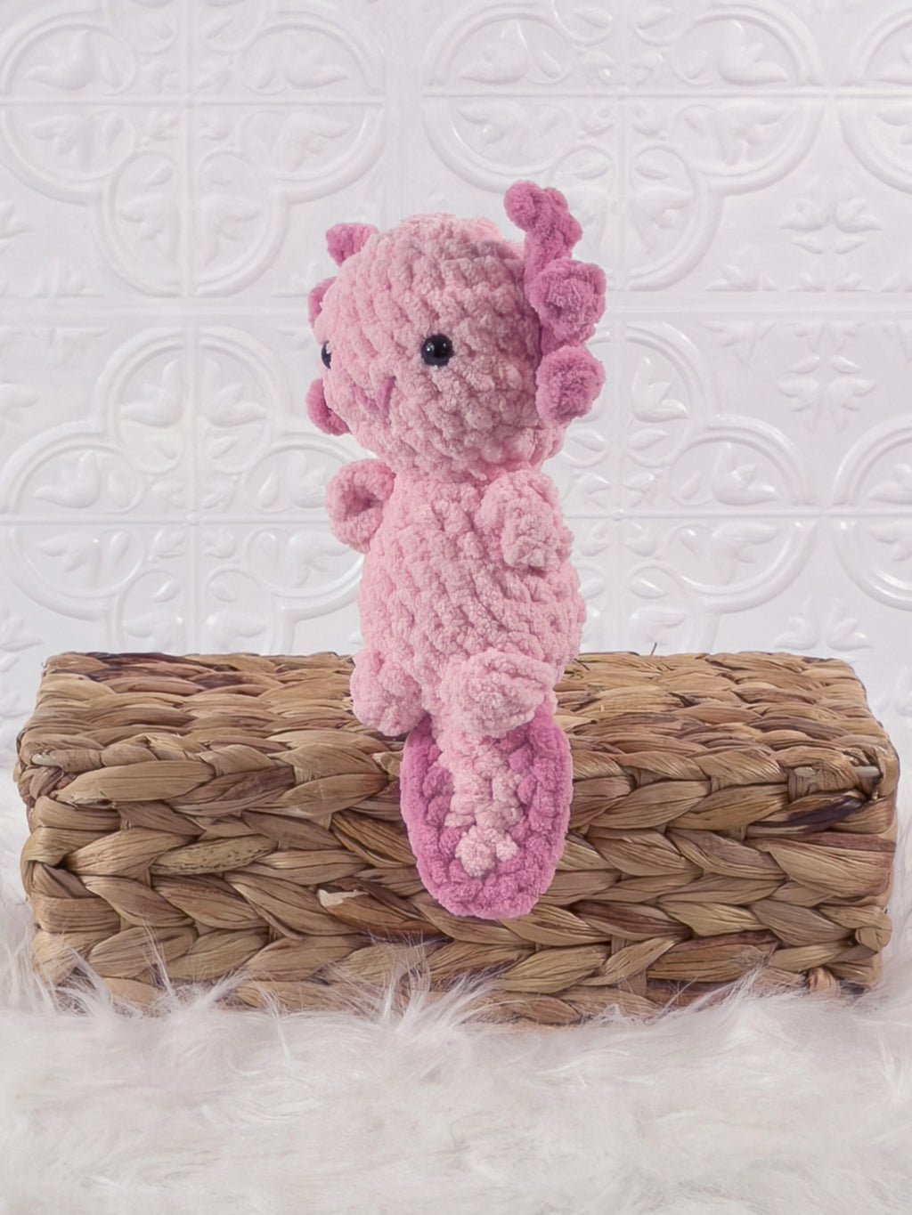 Handmade pink , dark axolotl crochet plushie shown from the front