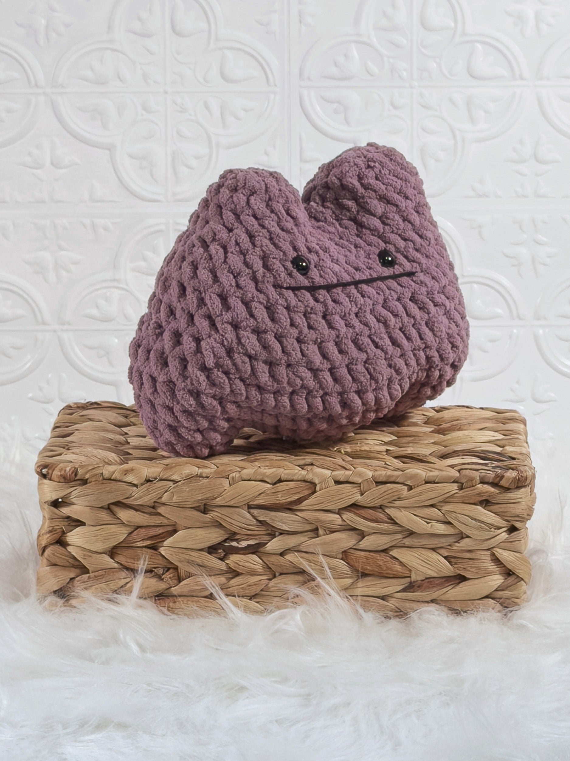 Handmade purple ditto crochet plushie shown from an angled view