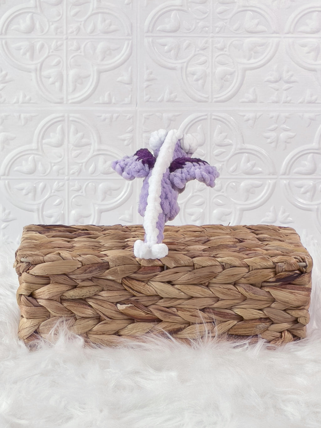 Handmade purple mini dragon crochet plushie shown from the back