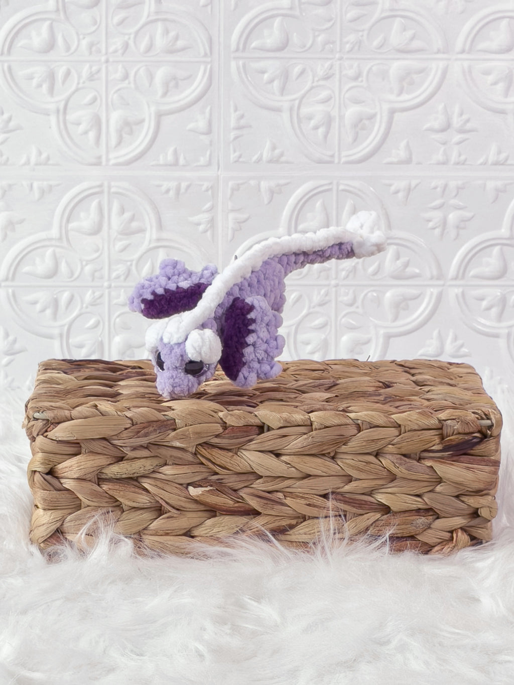 Small handmade dragon crochet plushie shown from the front