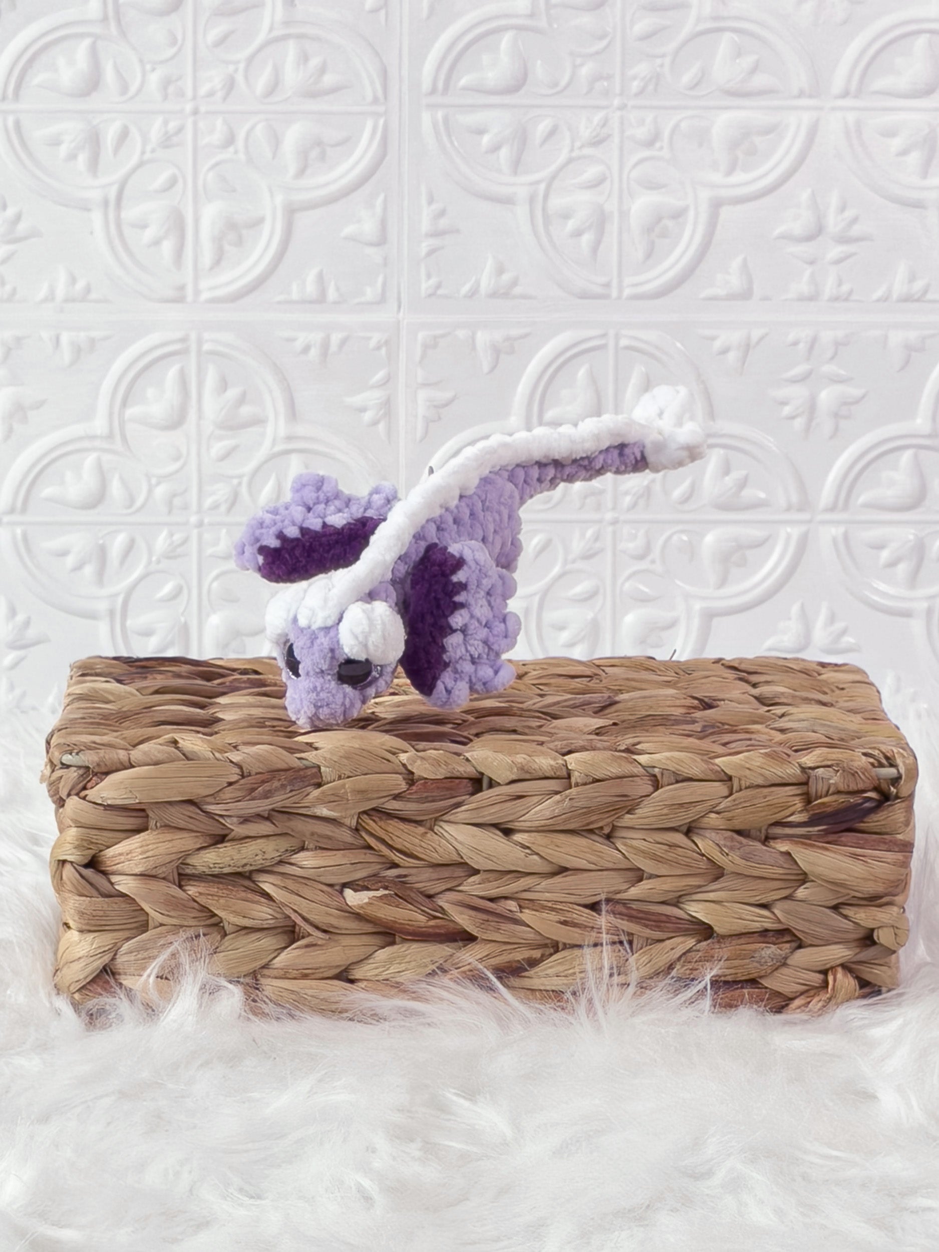 Small handmade dragon crochet plushie shown from the front