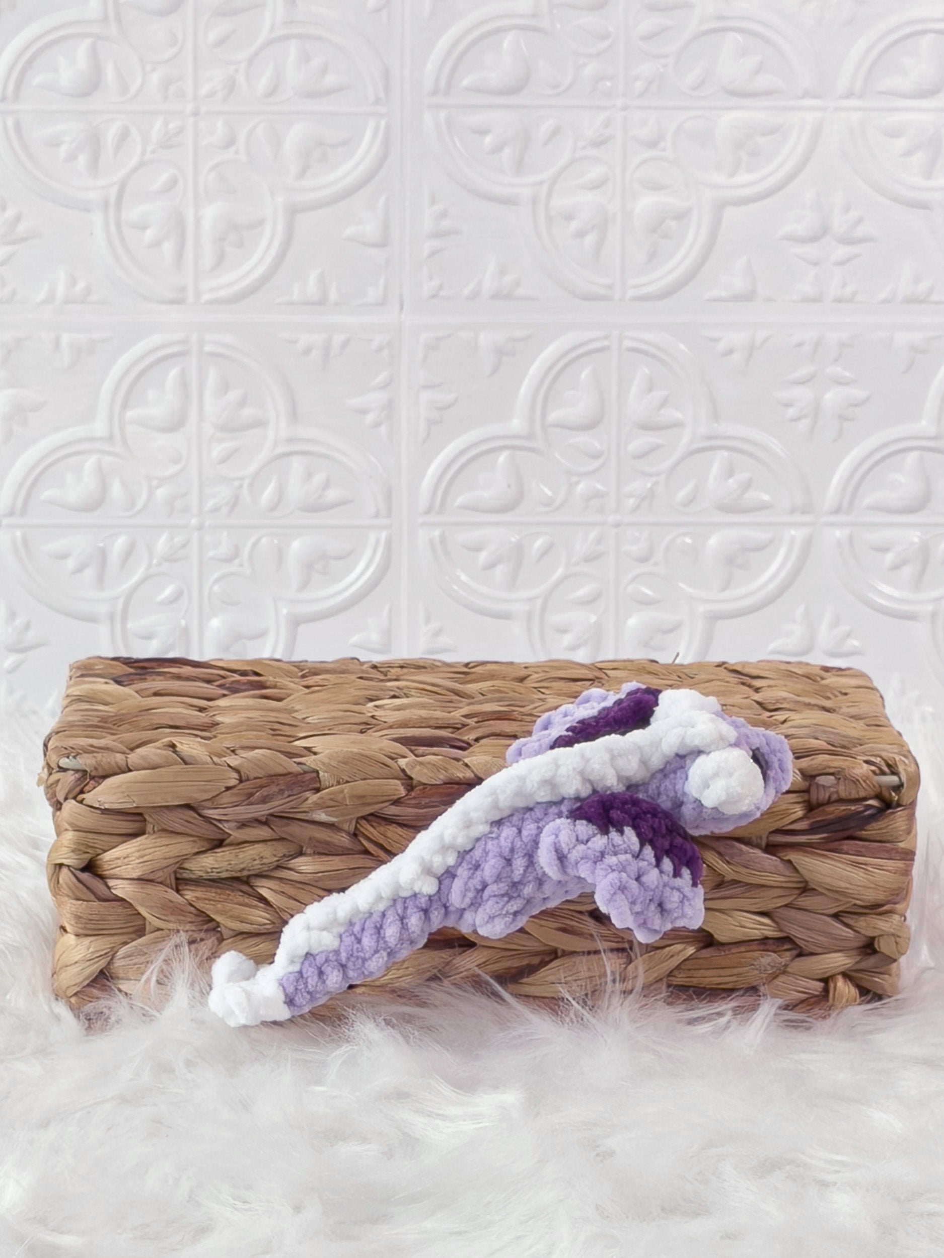Handmade purple mini dragon crochet plushie shown from the side