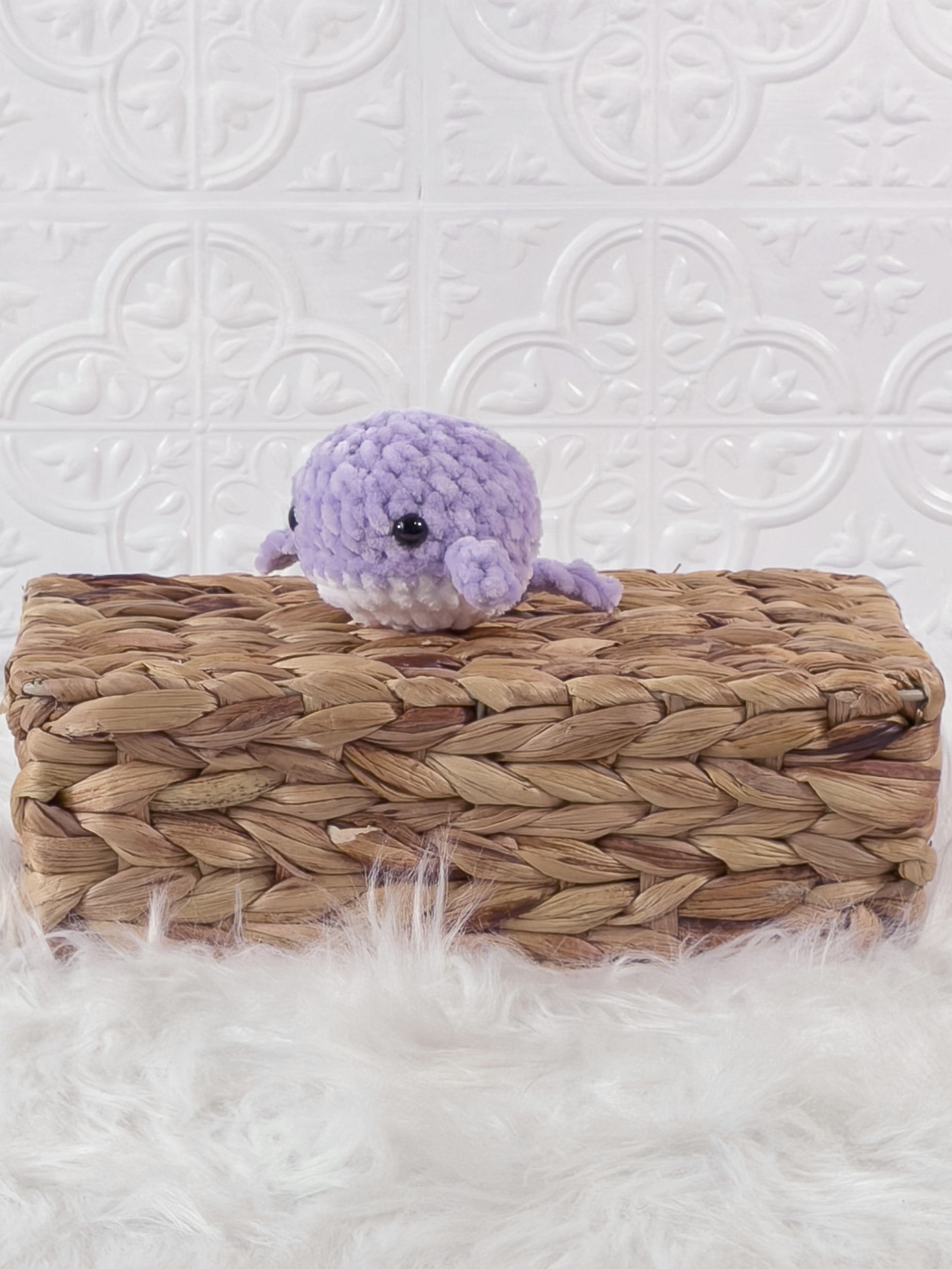 Small handmade whale crochet plushie shown from the front