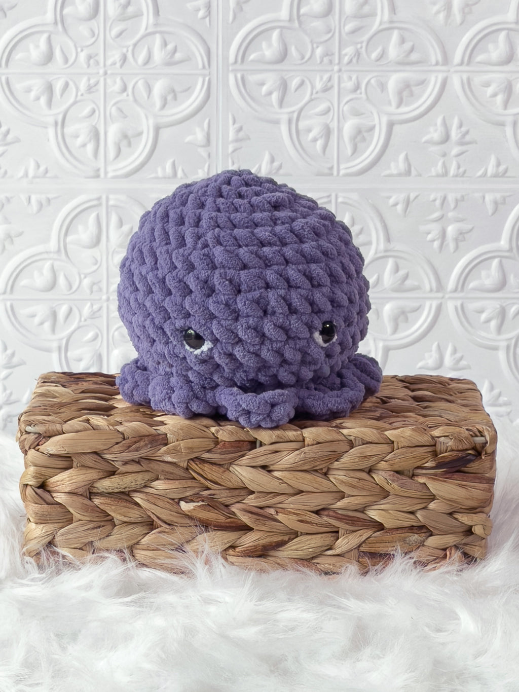 Handmade purple octopus crochet plushie shown from an angled view