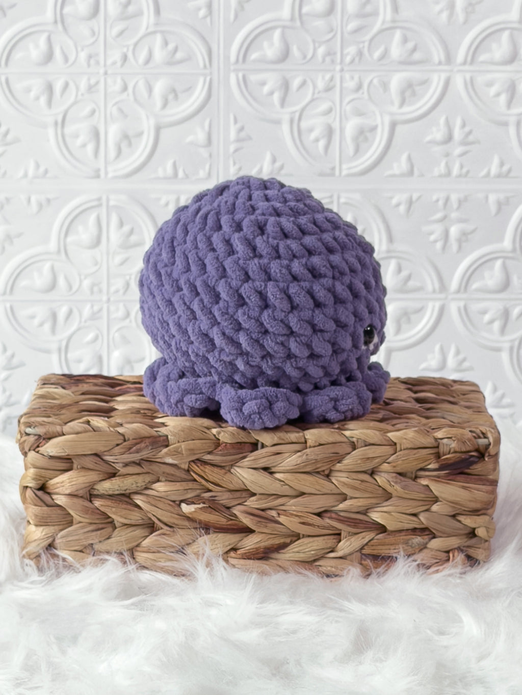 Handmade purple octopus crochet plushie shown from the back