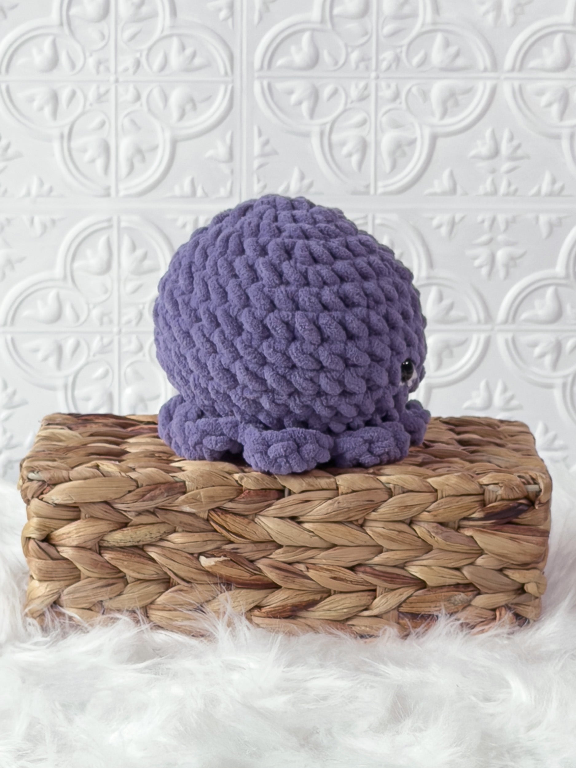 Handmade purple octopus crochet plushie shown from the back