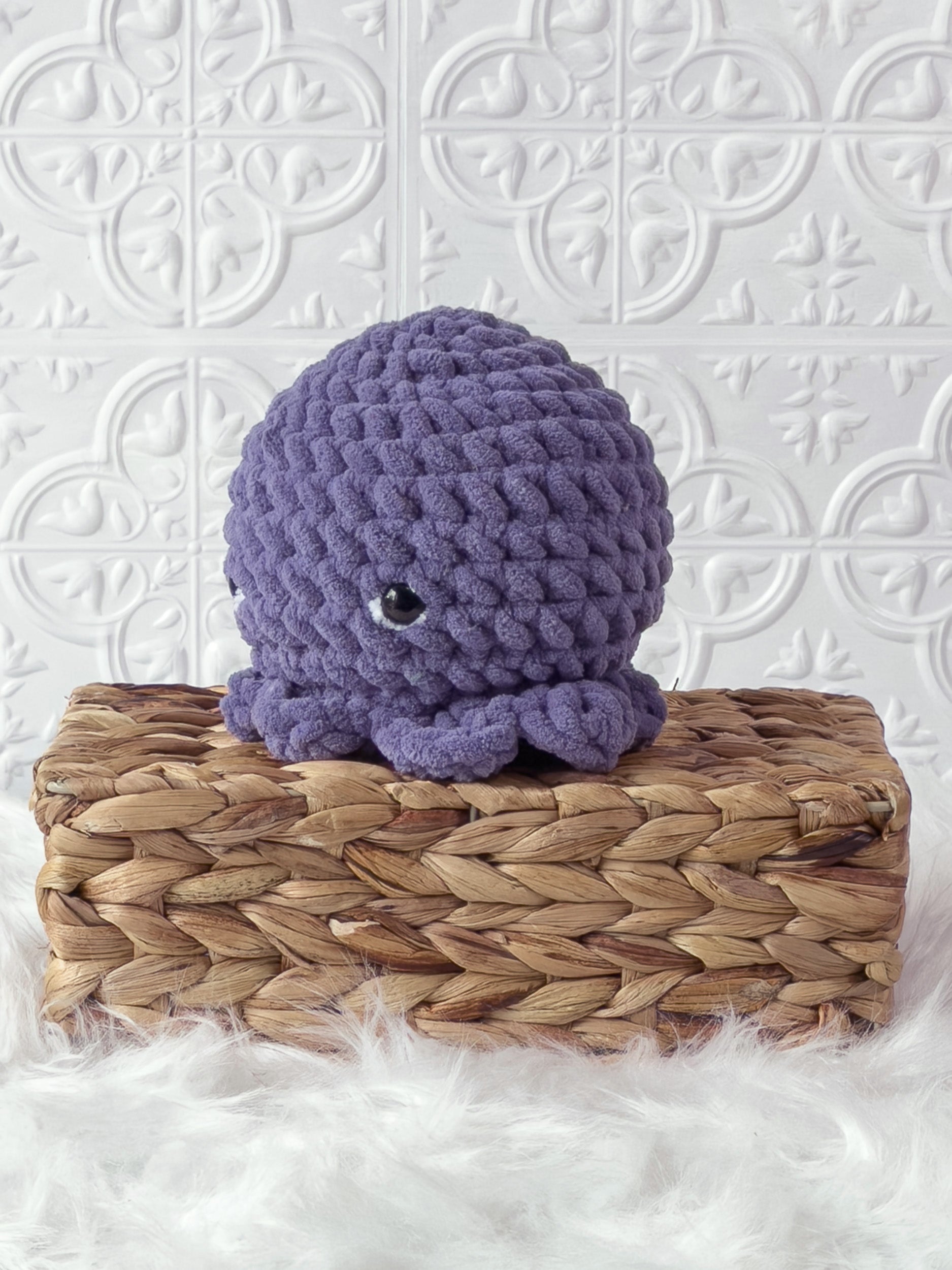 Handmade purple octopus crochet plushie shown from the front