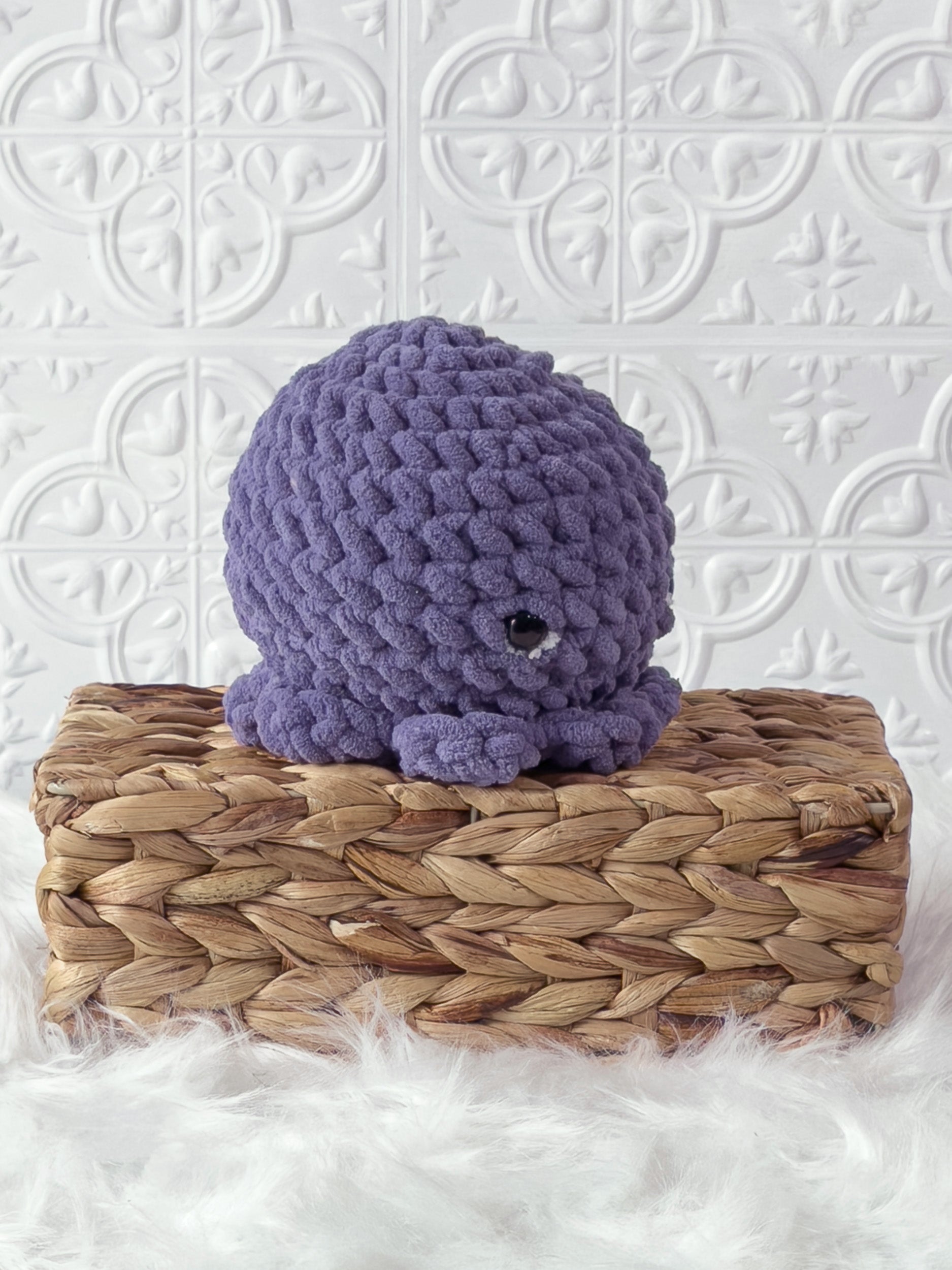 Handmade purple octopus crochet plushie shown from the side