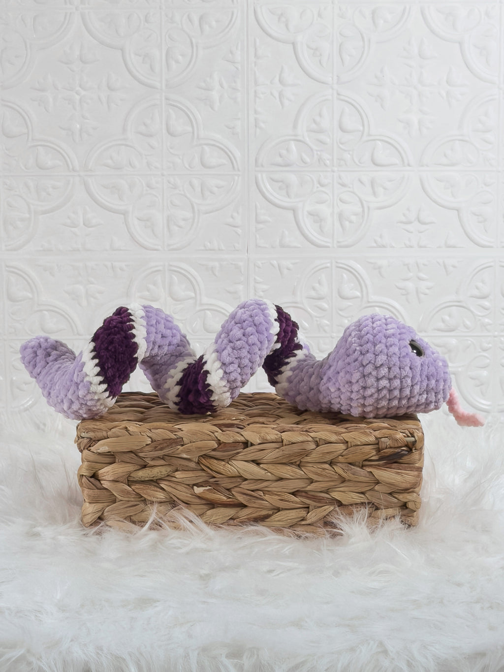 Handmade purple snake crochet plushie shown from the side