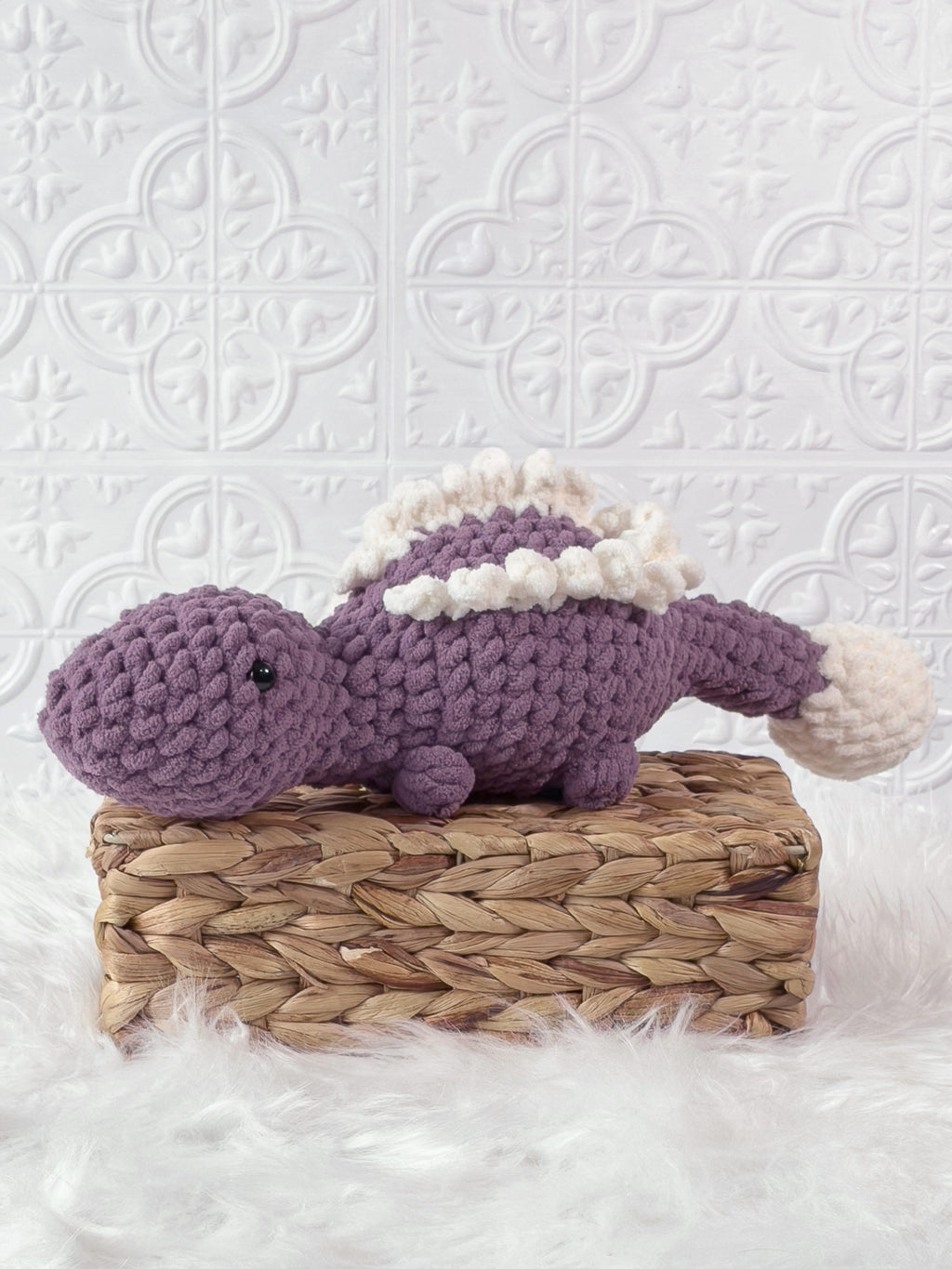 Handmade stegosaurus crochet plushie shown from the front
