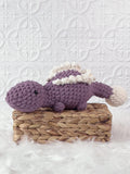 Handmade stegosaurus crochet plushie shown from the front