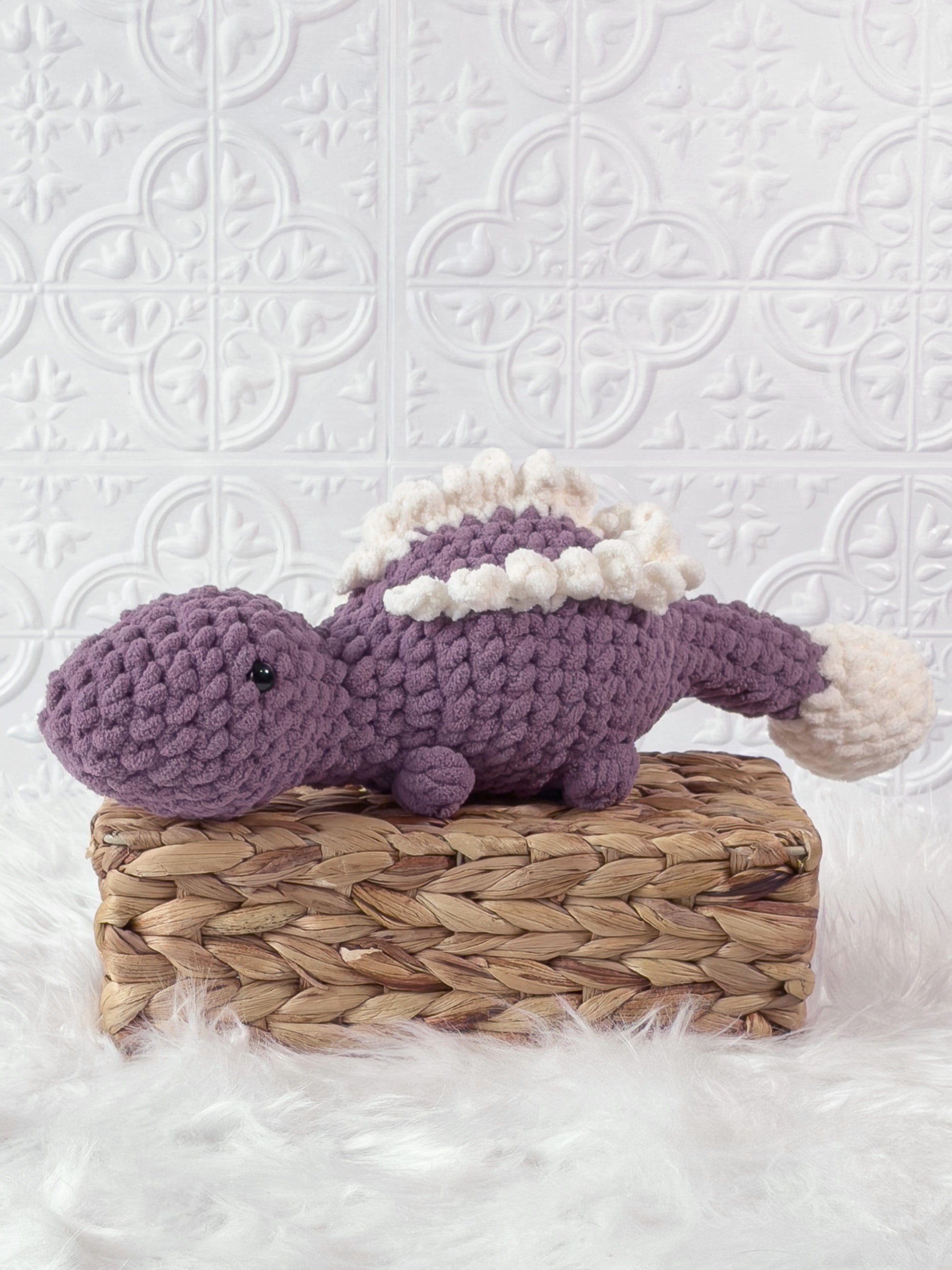 Handmade stegosaurus crochet plushie shown from the front