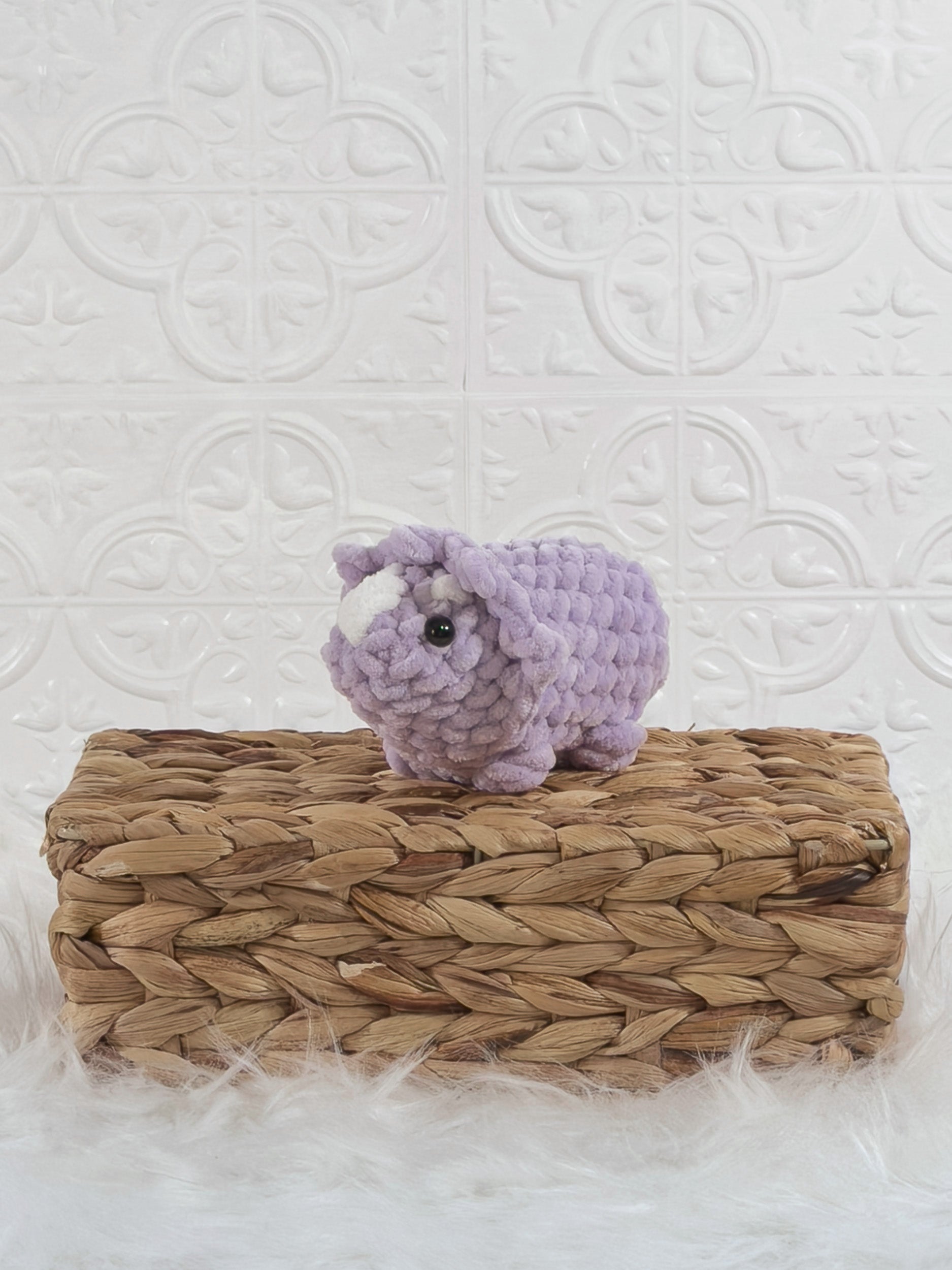 Handmade triceratops crochet plushie shown from the front