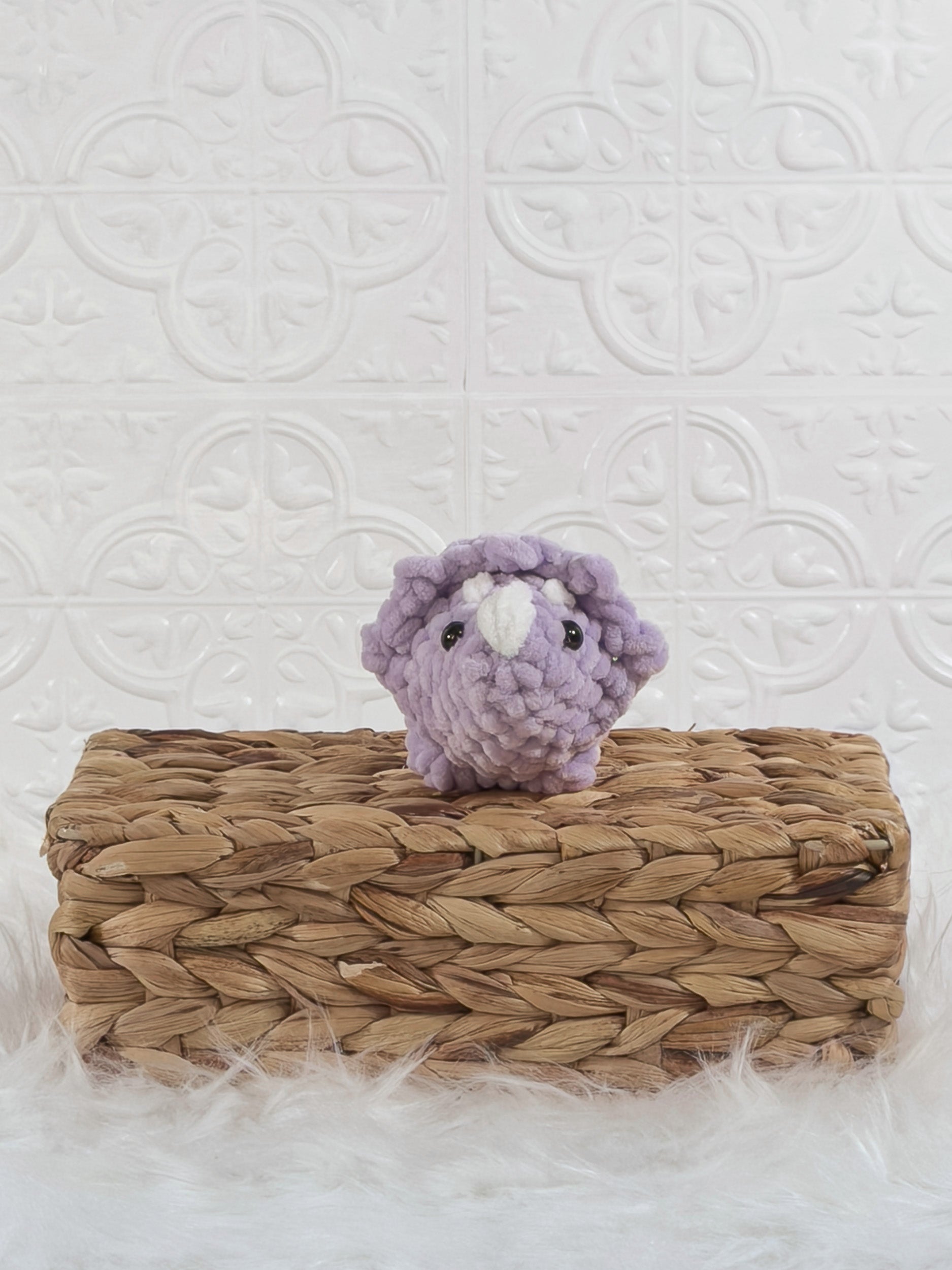 Handmade purple triceratops crochet plushie shown from the front