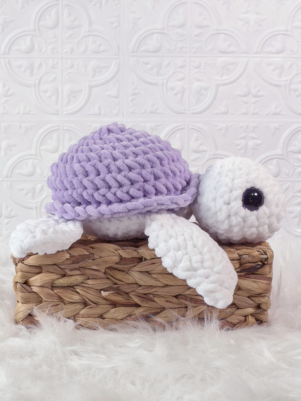 Handmade purple turtle crochet plushie shown from an angled view