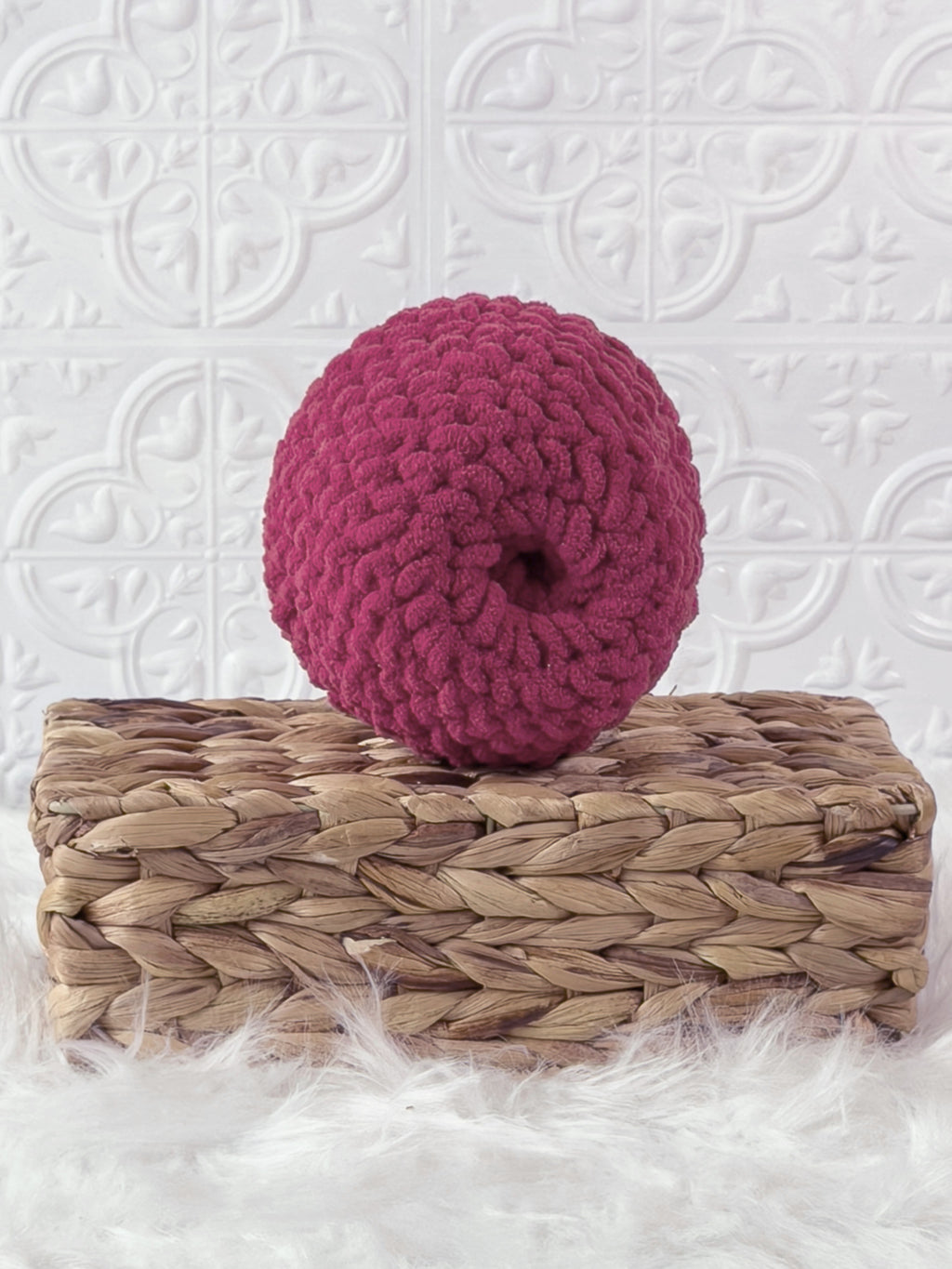 Handmade red apple crochet plushie shown from the back
