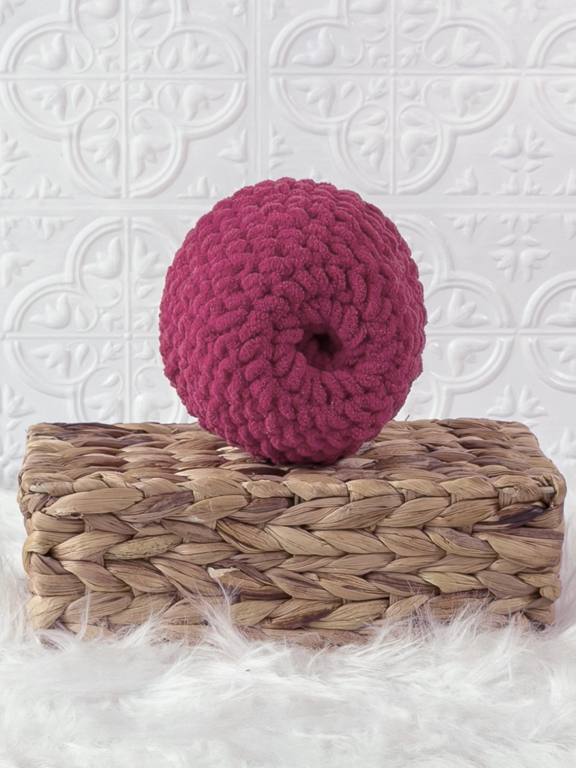 Handmade red apple crochet plushie shown from the back