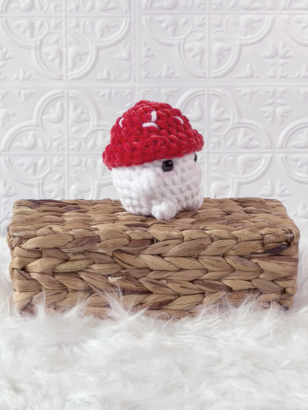 Handmade red chonky mushroom crochet plushie shown from an angled view