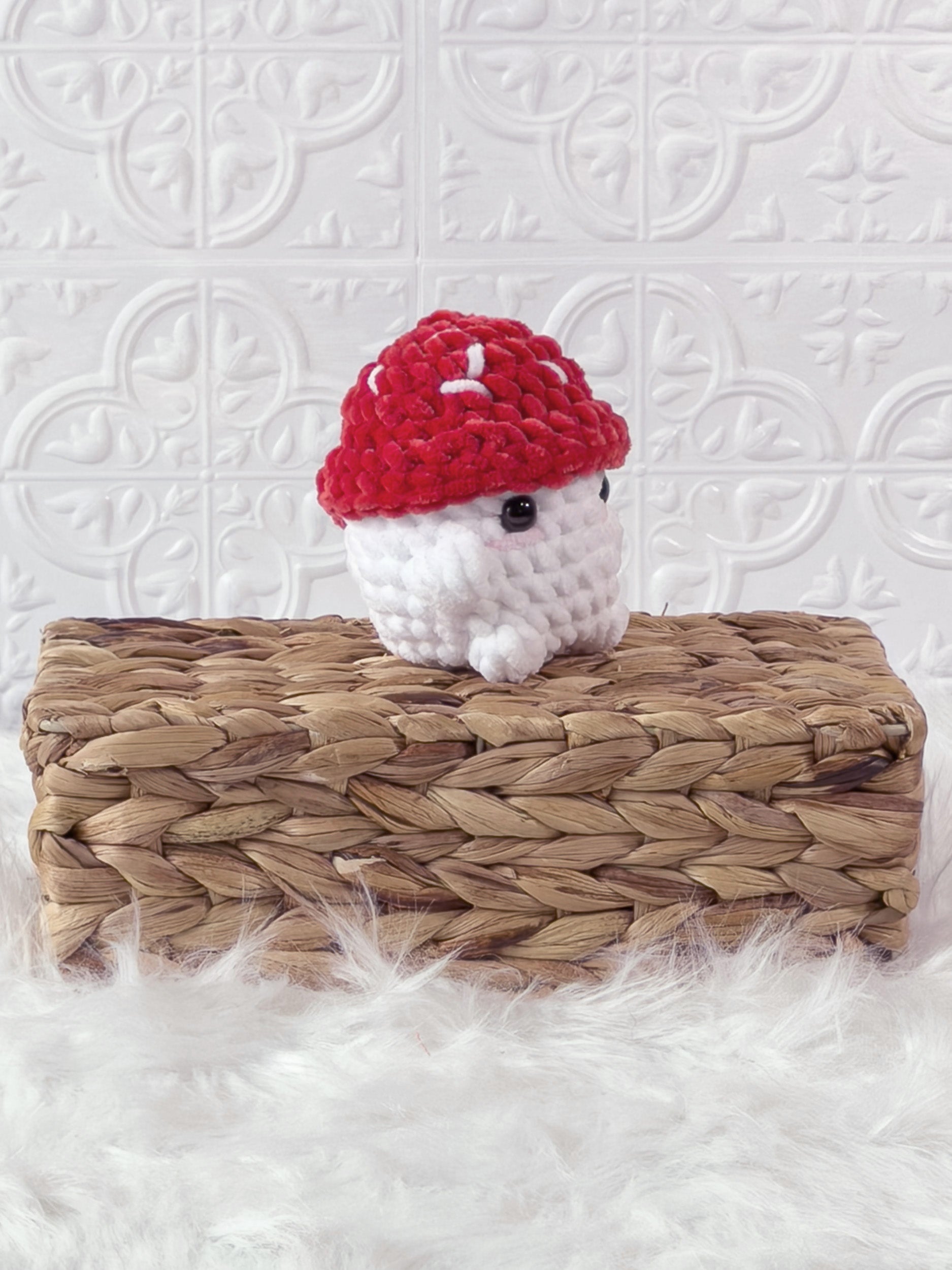 Handmade red chonky mushroom crochet plushie shown from an angled view