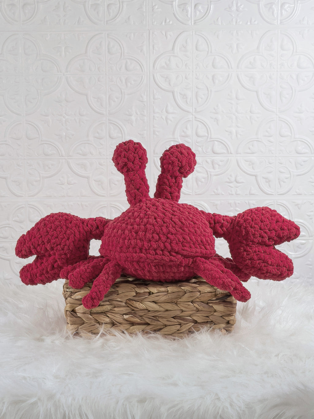 Handmade red crab crochet plushie shown from the back