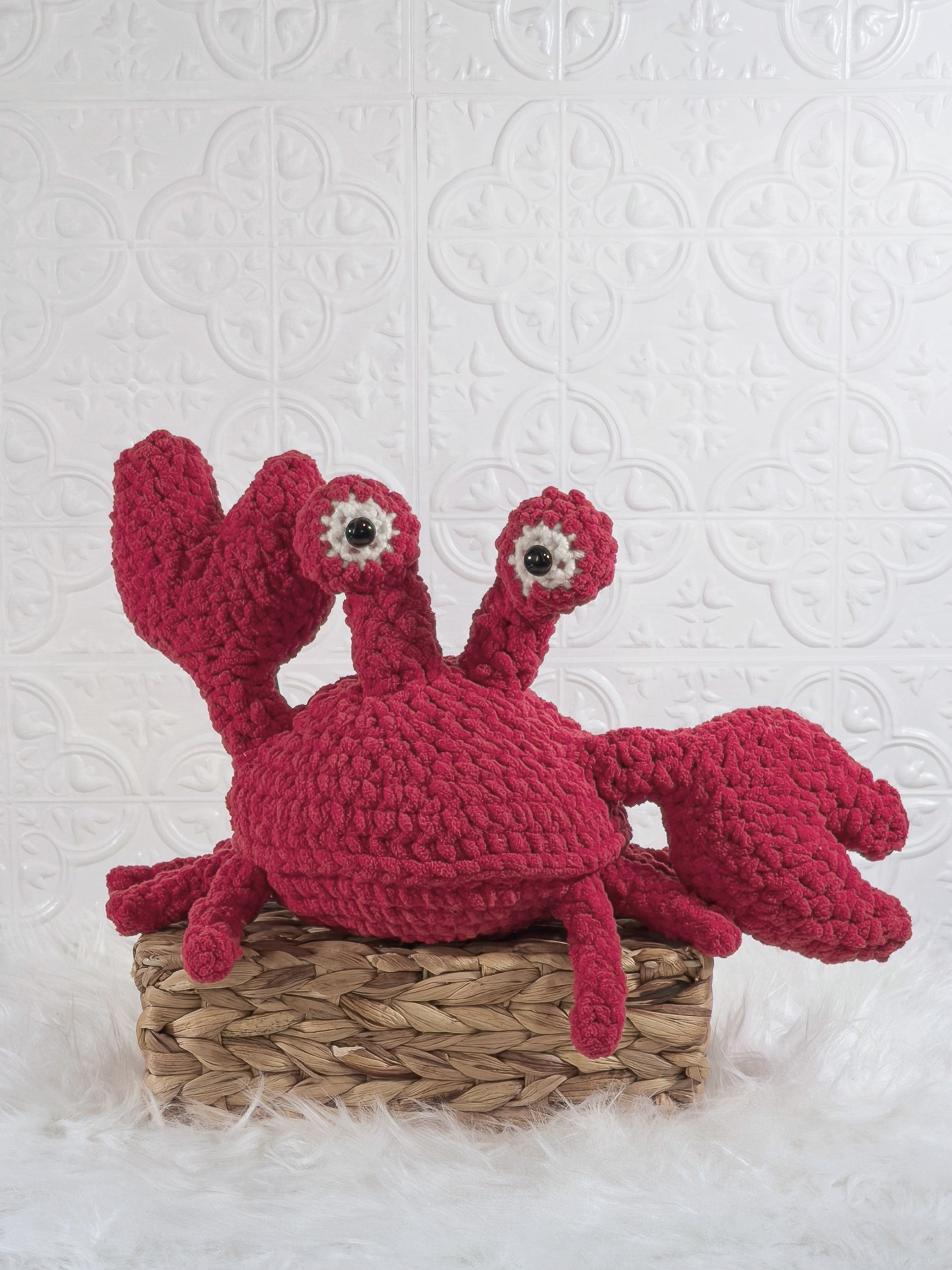 Handmade red crab crochet plushie shown from the front