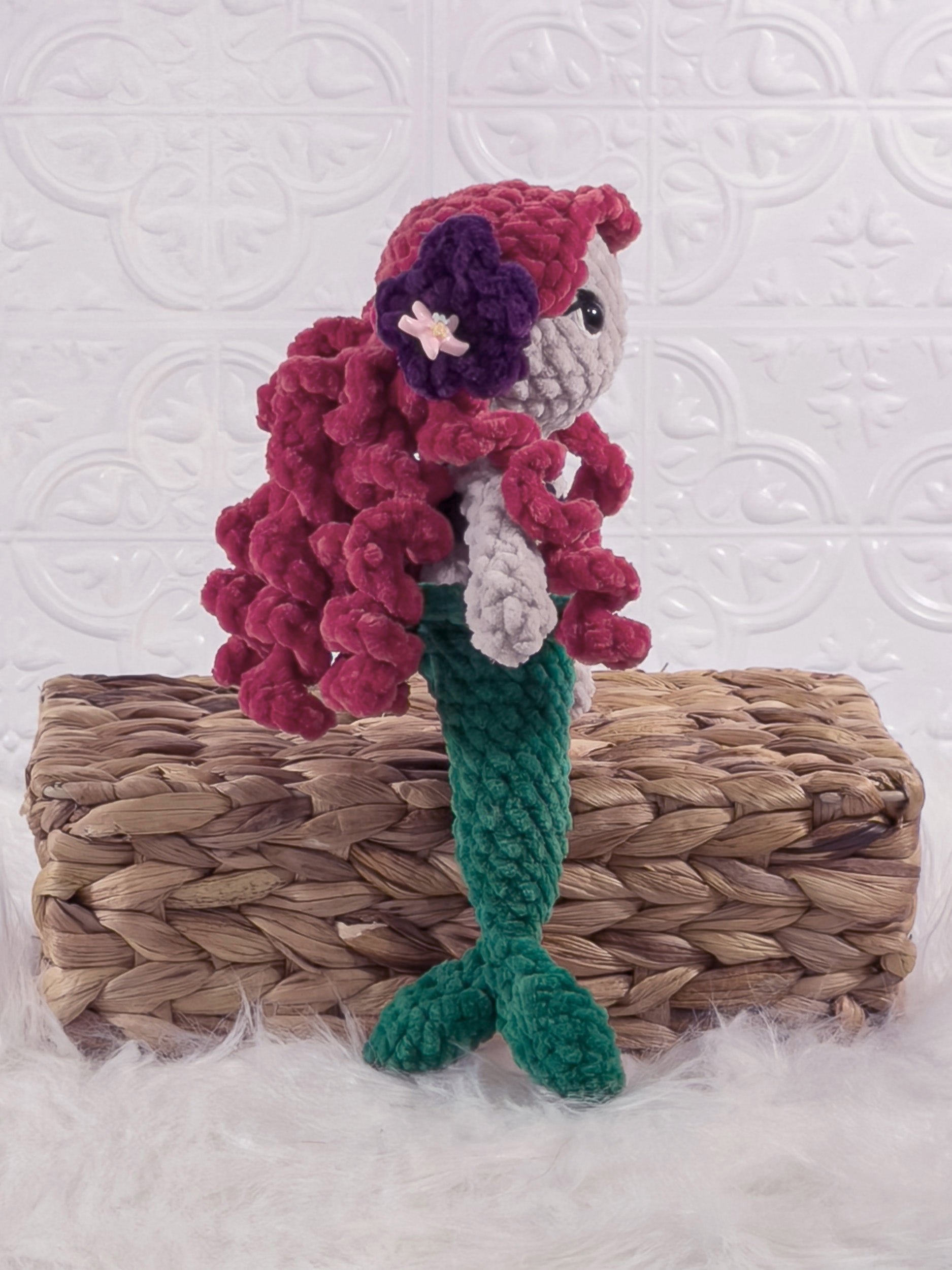 Handmade red mermaid crochet plushie shown from an angled view