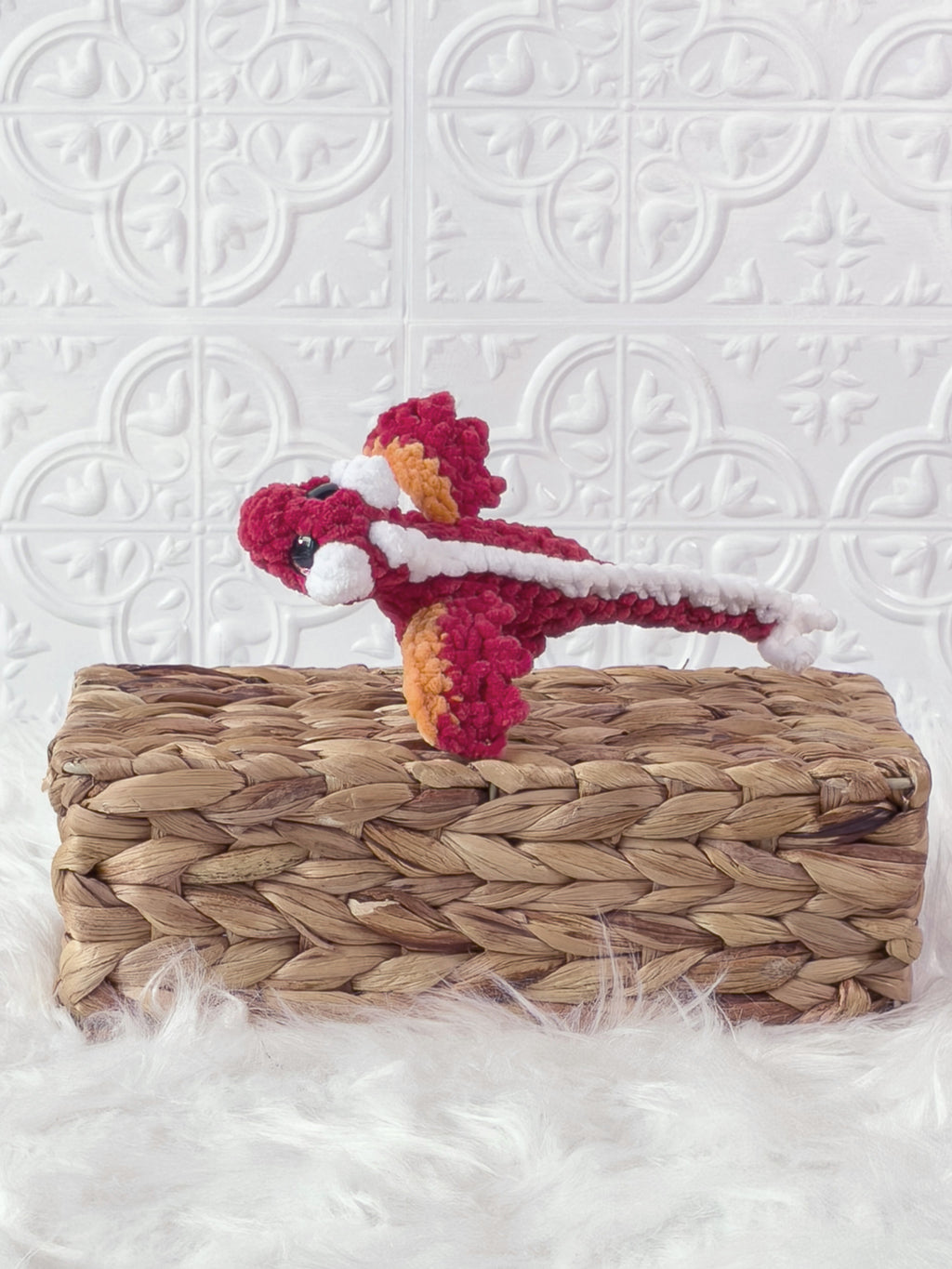 Small handmade dragon crochet plushie shown from the front
