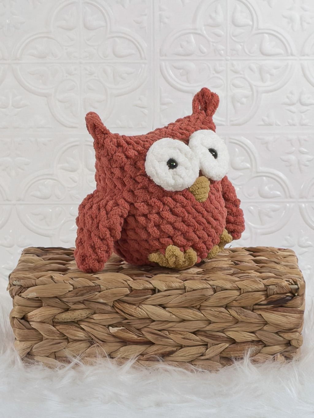 Handmade red owl crochet plushie shown from an angled view