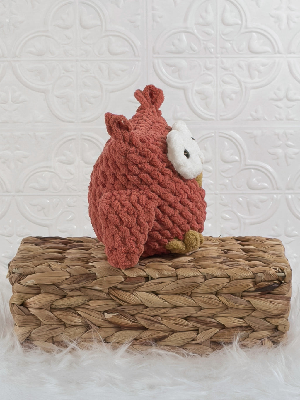 Handmade red owl crochet plushie shown from the side