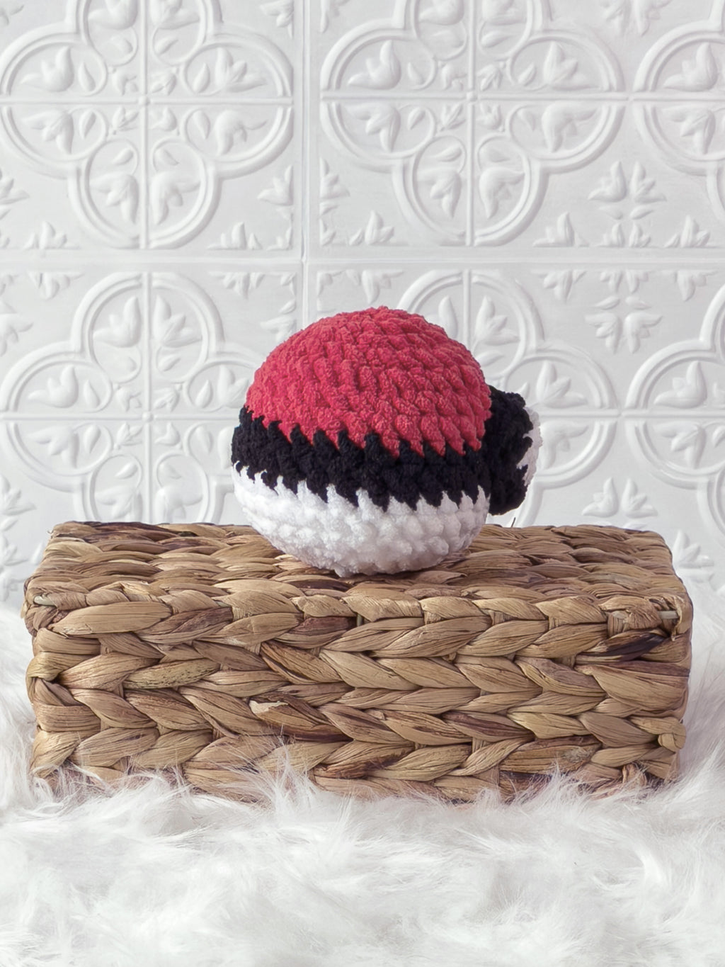 Handmade red poke ball crochet plushie shown from the back